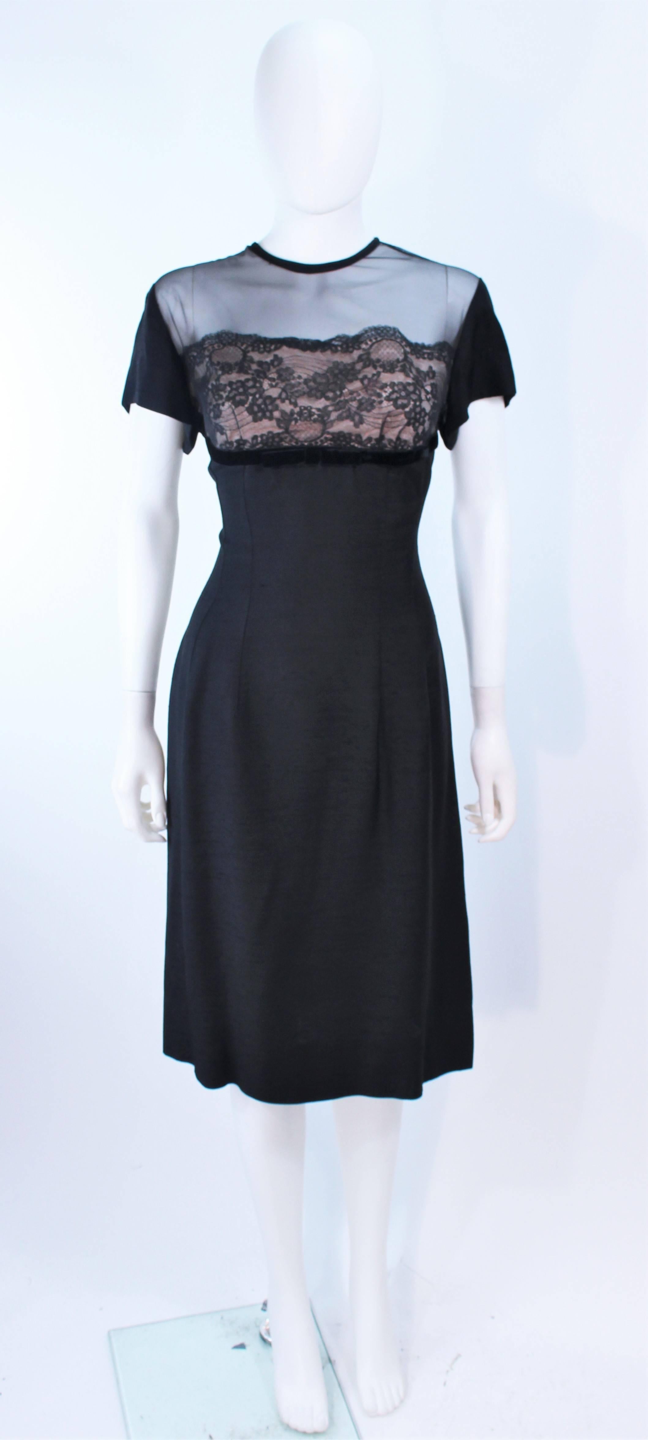 This J. Harlan design is composed of a black silk with a mesh bust detail and lace accents. There is a center back zipper closure. In excellent vintage condition.

**Please cross-reference measurements for personal accuracy. Size in description