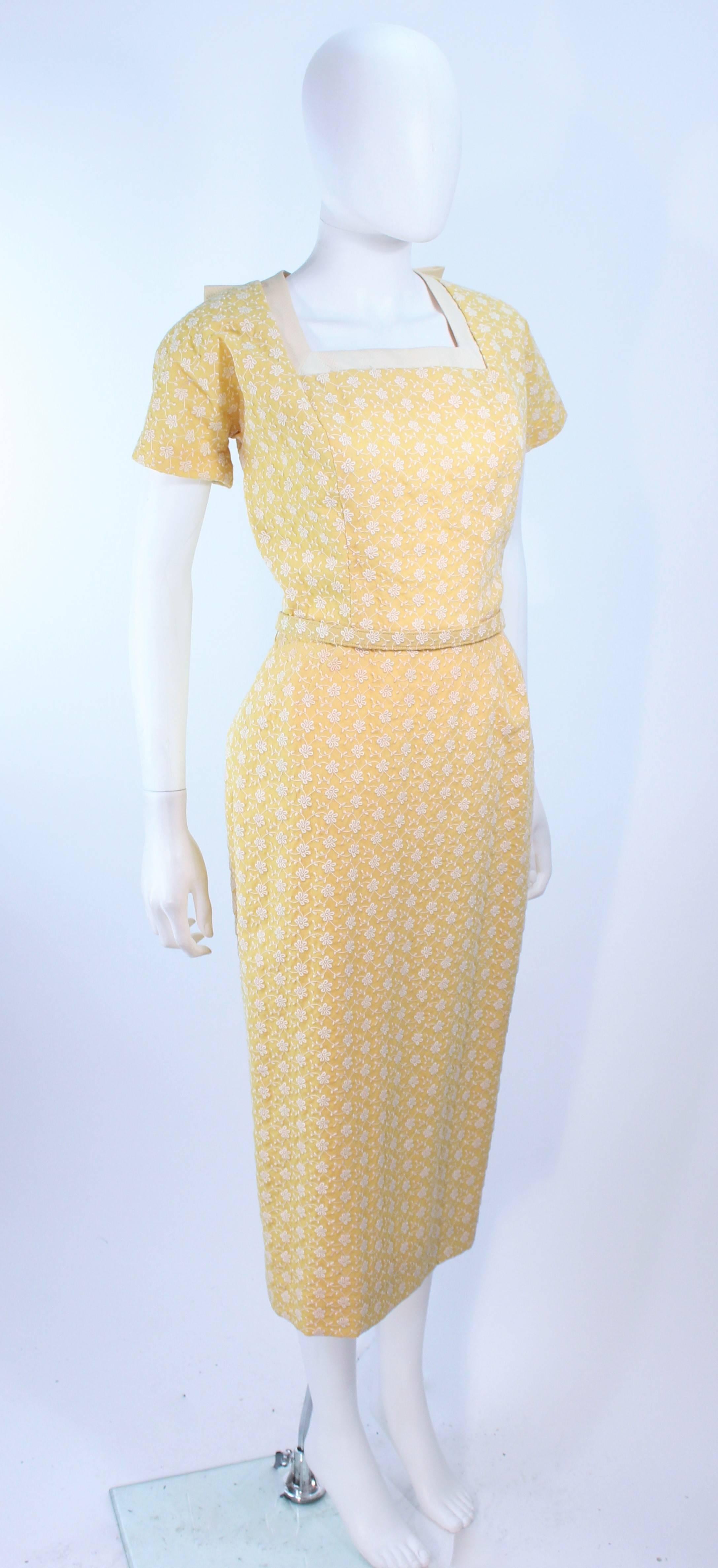 This Don Loper design is composed of a yellow embroidered floral print fabric. Features a center back of the neck bow. There is a center back zippre closure. In excellent vintage condition.

**Please cross-reference measurements for personal