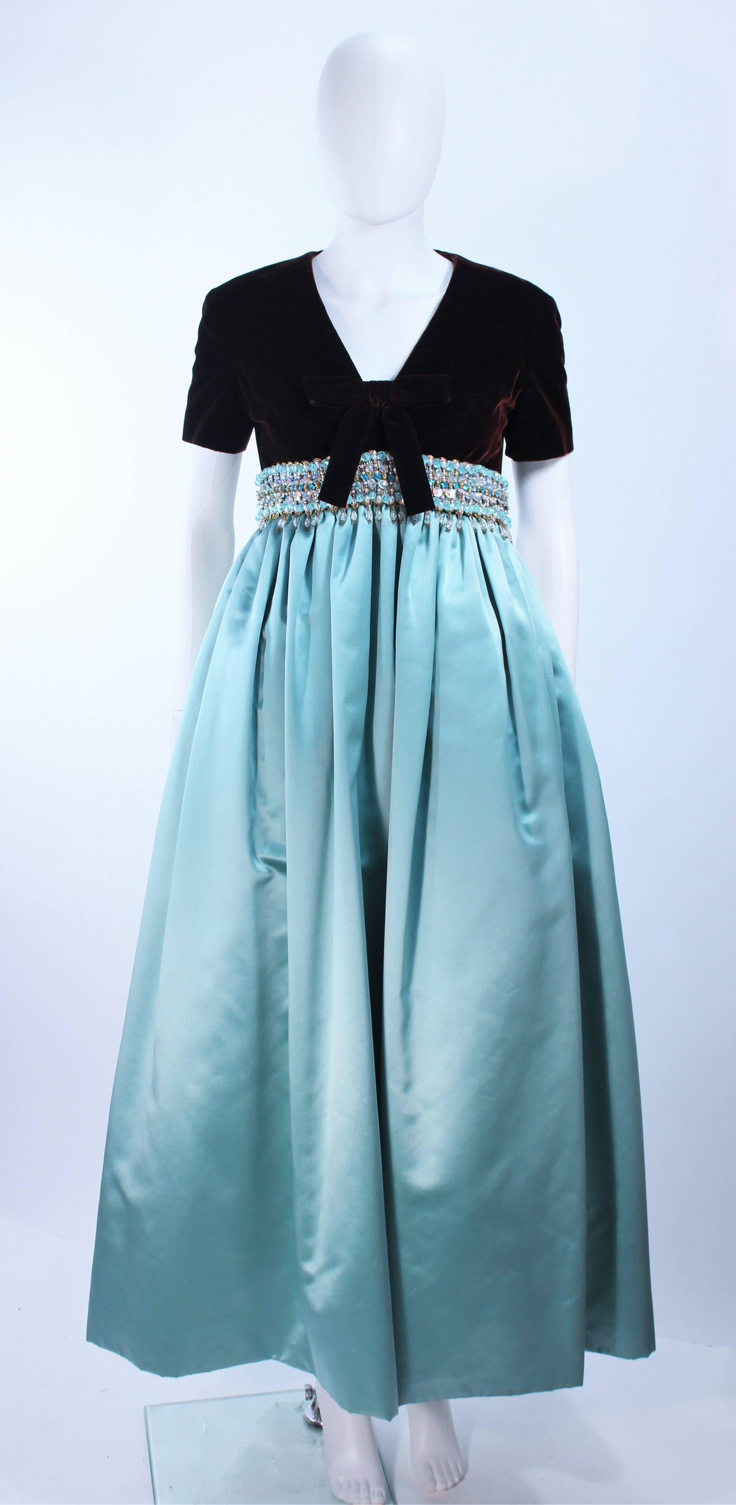 This Sarmi gown is composed of a brown velvet bodice with an embellished waist and silk aqua skirt. Features a center front bow detail. There is a center back zipper closure. In excellent vintage condition.

**Please cross-reference measurements
