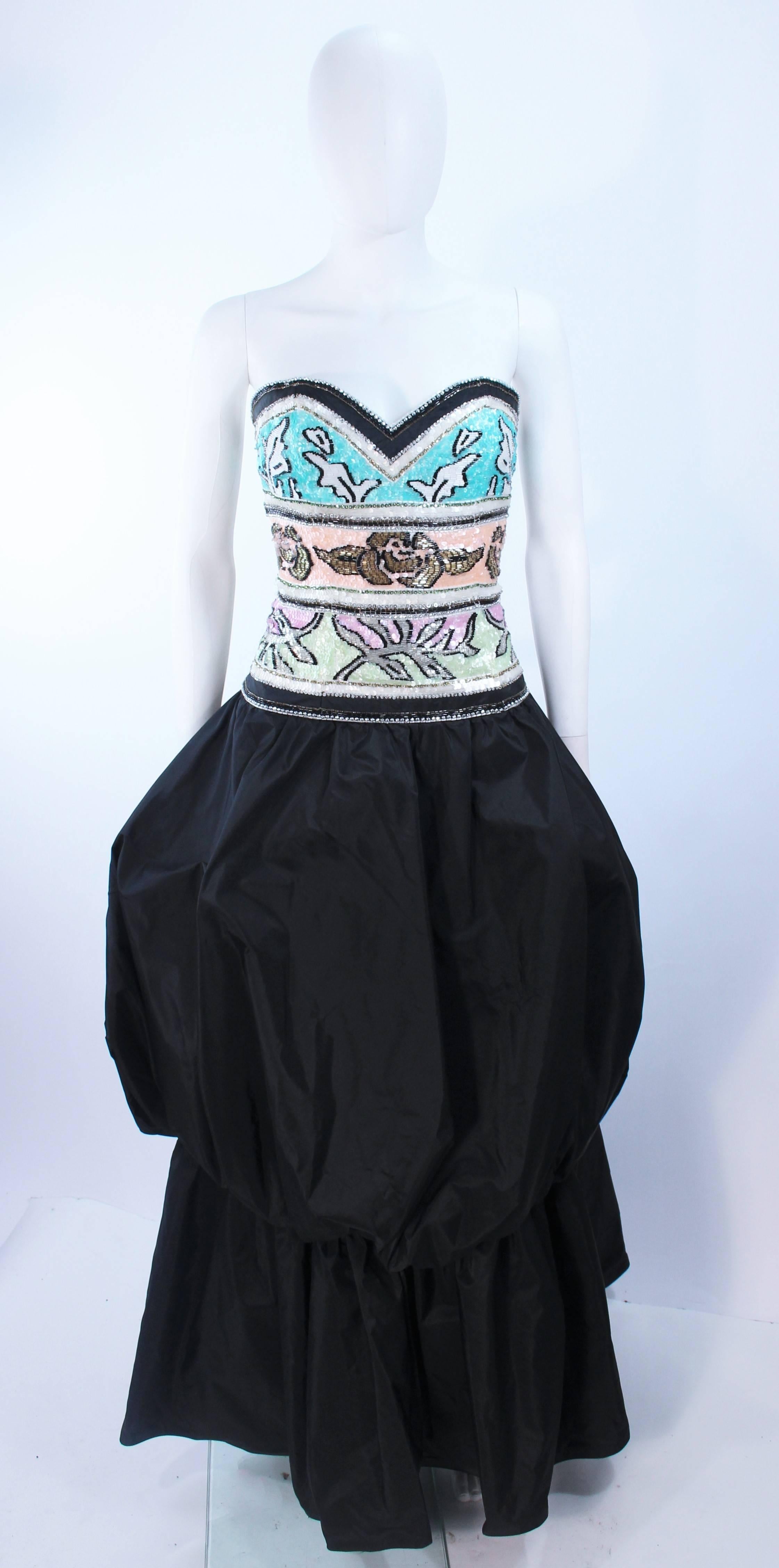 This Brian Winston gown is composed of a tiered black puff skirt with a beaded sequin bodice. Features a center back zipper closure. In excellent vintage condition.

**Please cross-reference measurements for personal accuracy. Size in description