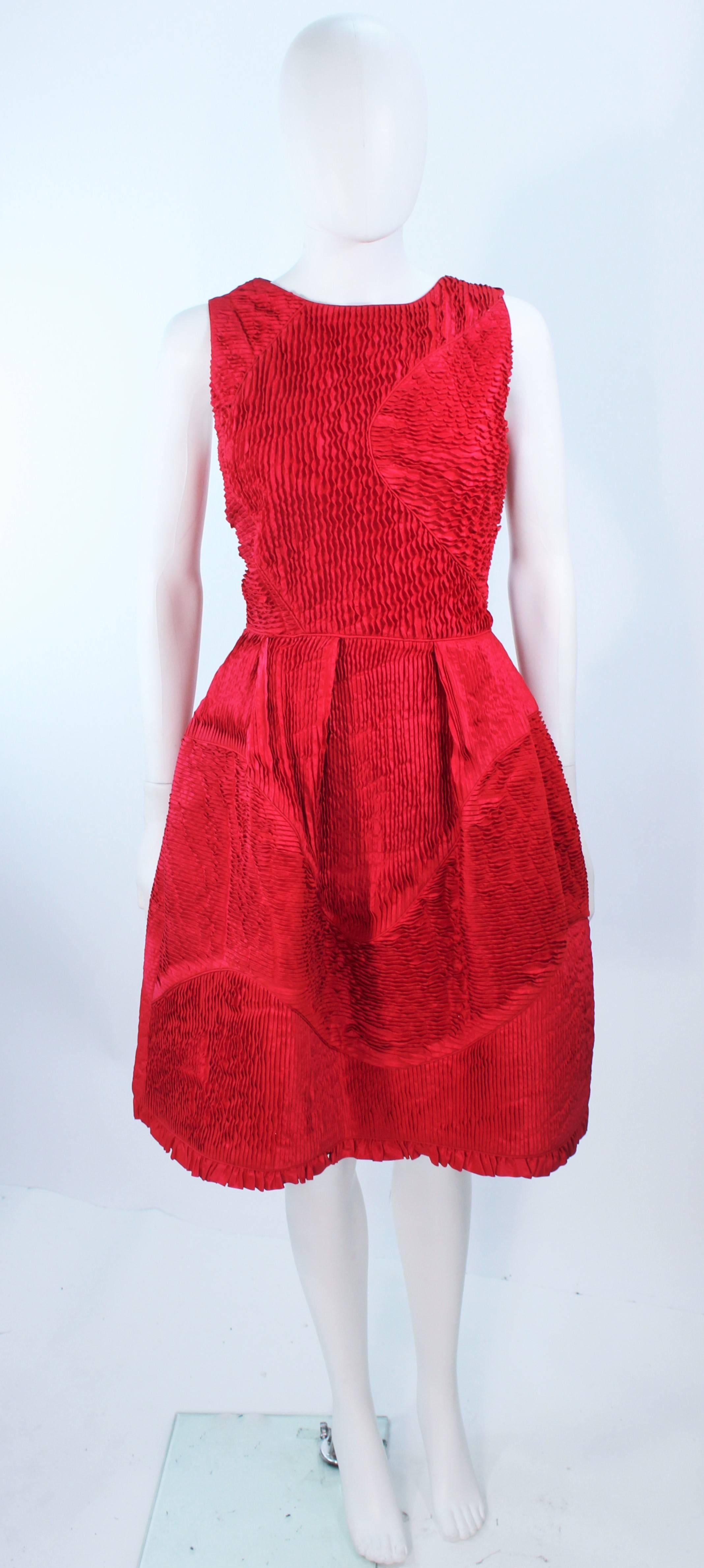 This Oscar De La Renta cocktail dress is composed of a red silk with a pintucked gathered design. Features a side zipper closure with shoulder  buttons. In excellent vintage condition.

**Please cross-reference measurements for personal accuracy.