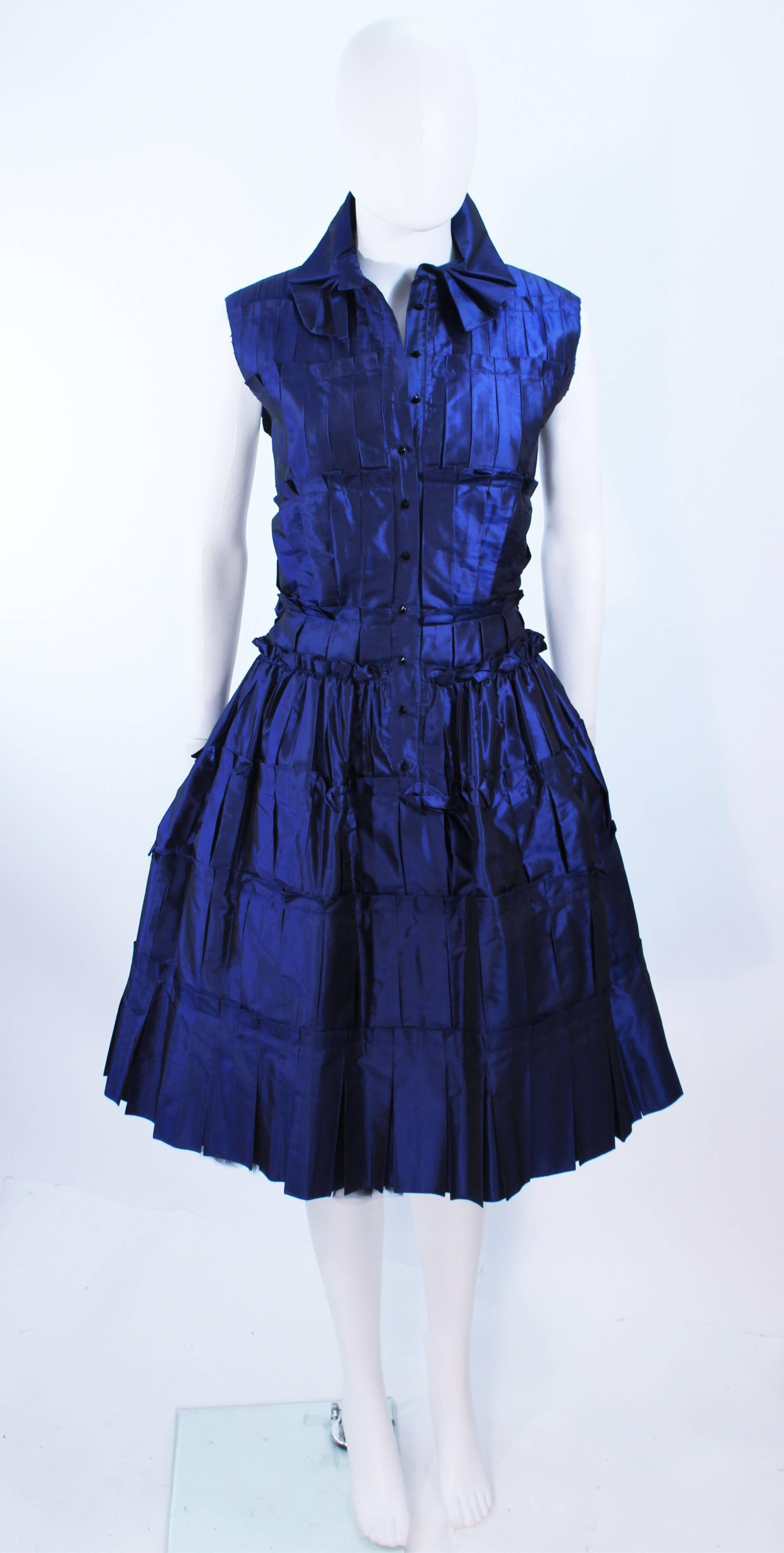 This Oscar De La Renta cocktail dress is composed of a blue silk with a pintuck-pleat gathered design. Features center front button closures. Comes with an interior crinoline. In excellent pre-owned condition, barely used.

**Please