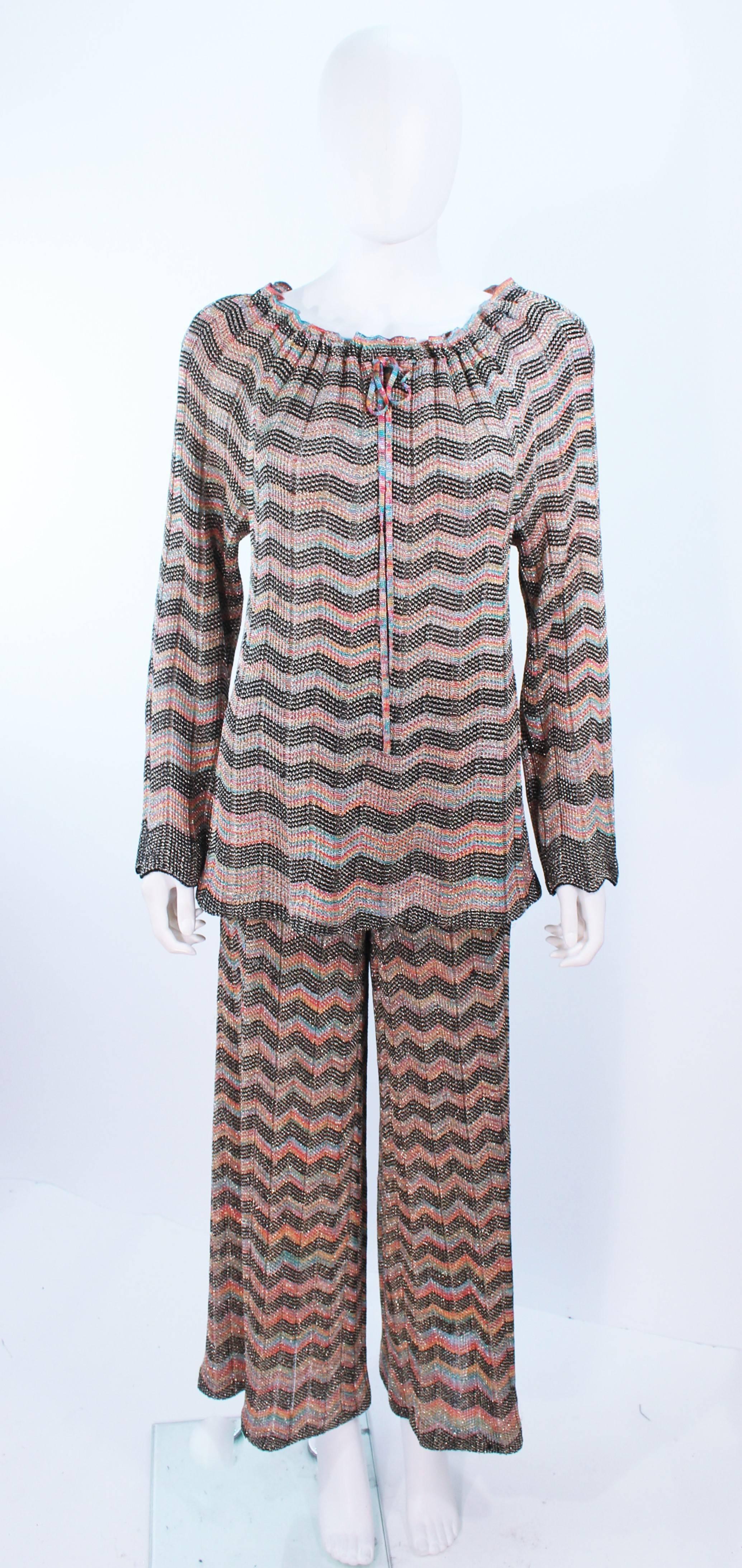 This Missoni design is composed of a metallic knit in a gold multi- color pattern. The blouse features a tie neck with shoulder pads, which can be removed to be worn off-the shoulder. In excellent vintage condition.

**Please cross-reference