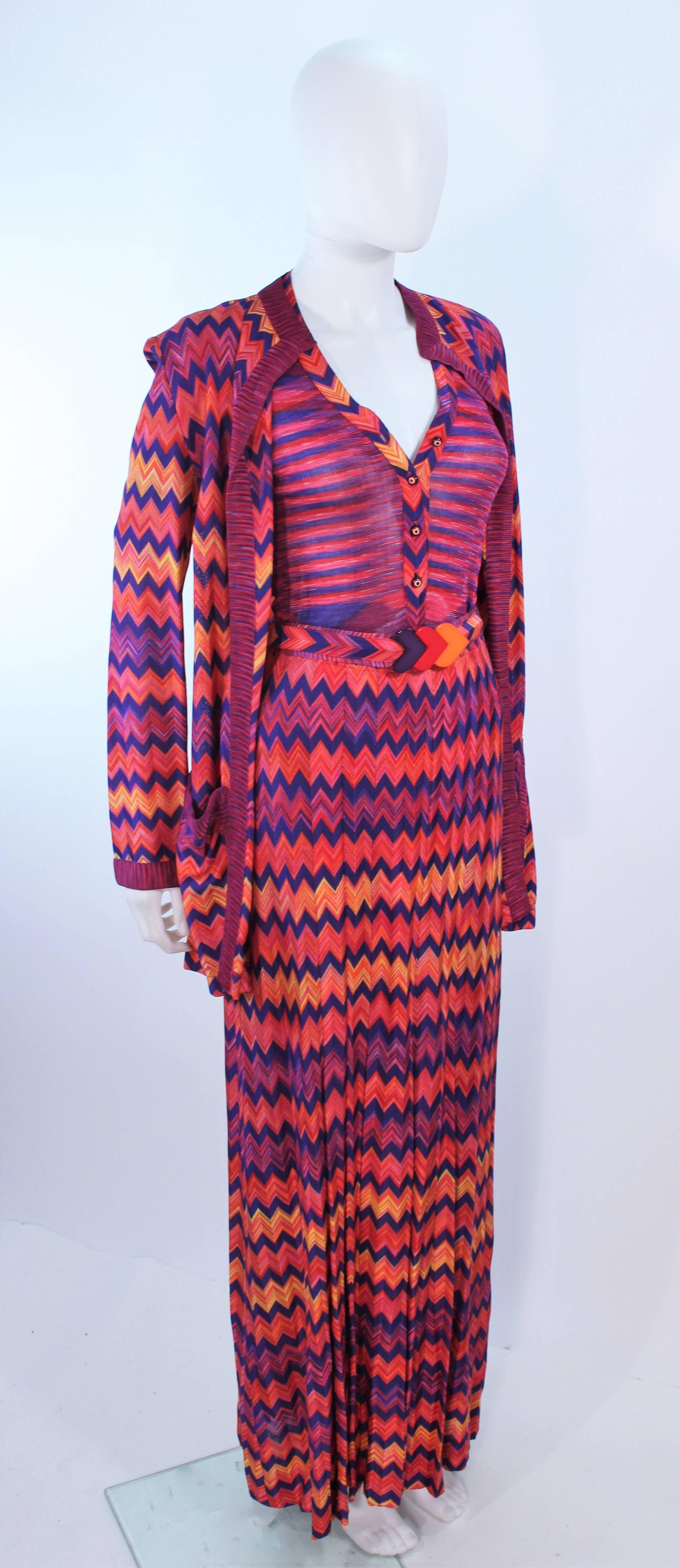This Missoni design is composed of a orange, purple, and fucshia zig zag knit. Features 5 pieces; an open style cardigan, a short sleeve top with glass buttons, a classic style skirt, and a Bakelite multi-color belt. In excellent vintage condition,