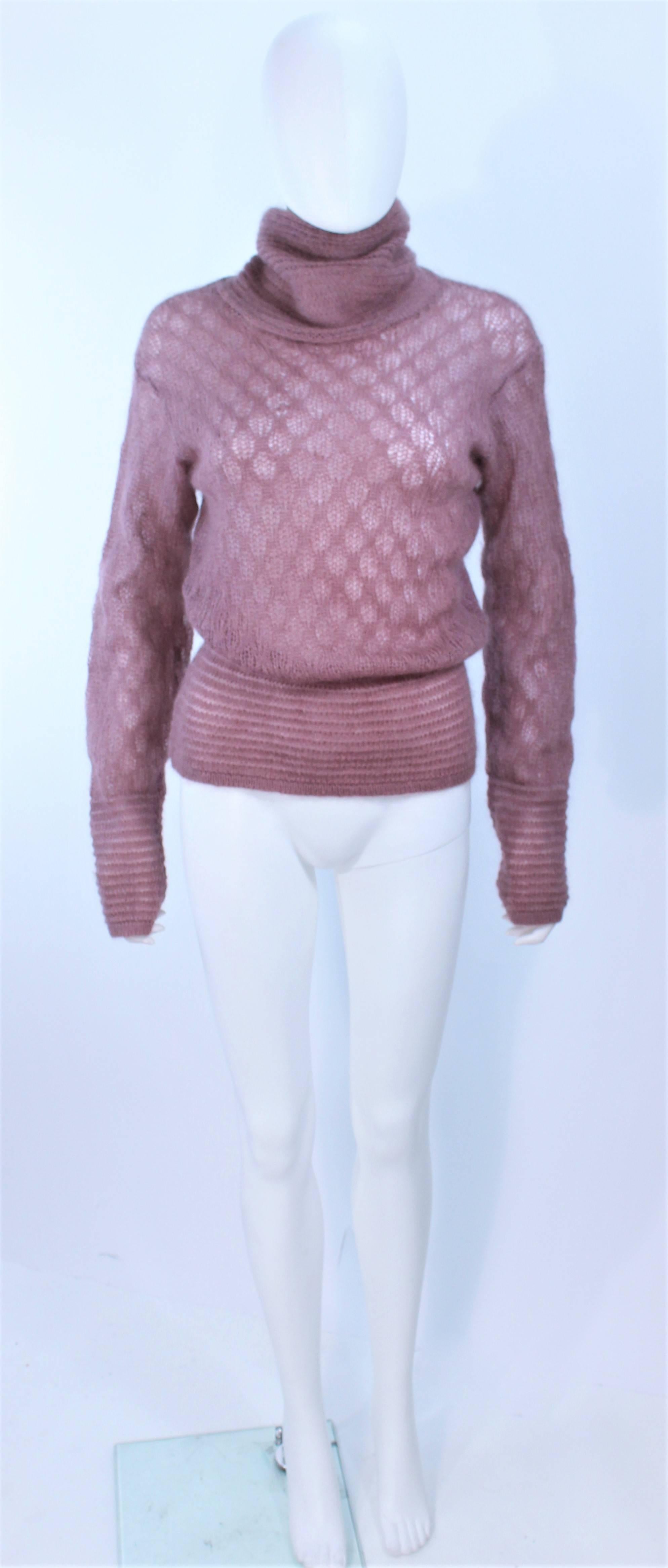 This Missoni design is composed of a mauve knit wool with a semi-sheer design. Features a turtle- cowl neck. In excellent vintage condition.

**Please cross-reference measurements for personal accuracy. Size in description box is an