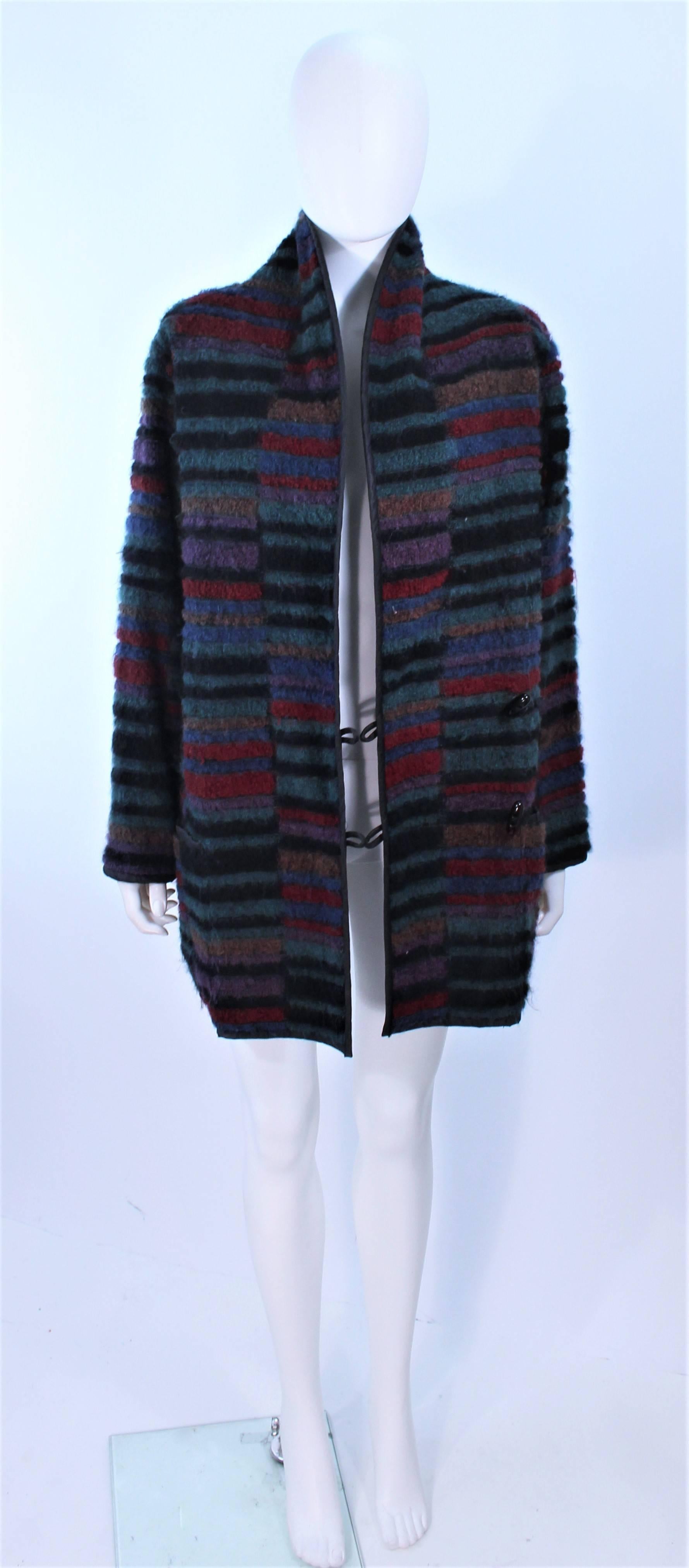 This Missoni design is composed of a multi-color knit and a reversible black quilted interior. Features a double breasted style with toggle button closures and pockets. In excellent vintage condition.

**Please cross-reference measurements for