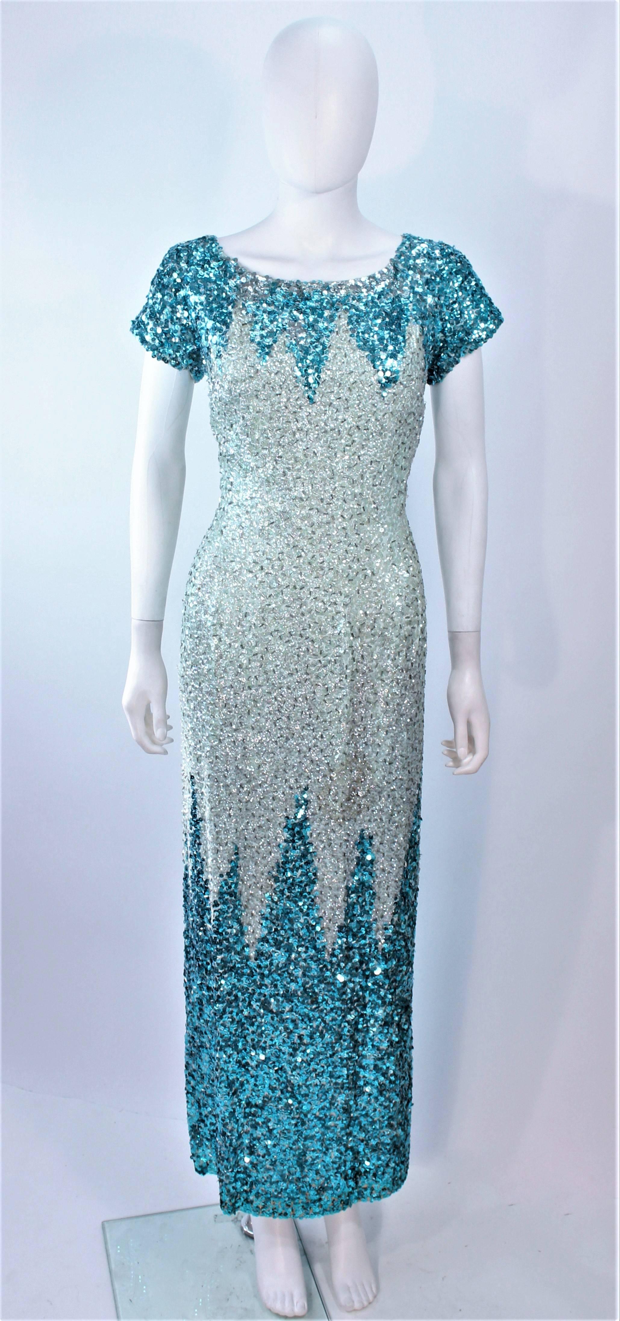 This vintage design is composed of sequins in aqua and turquoise hues. Features a center back zipper closure. In vintage condition, sold 