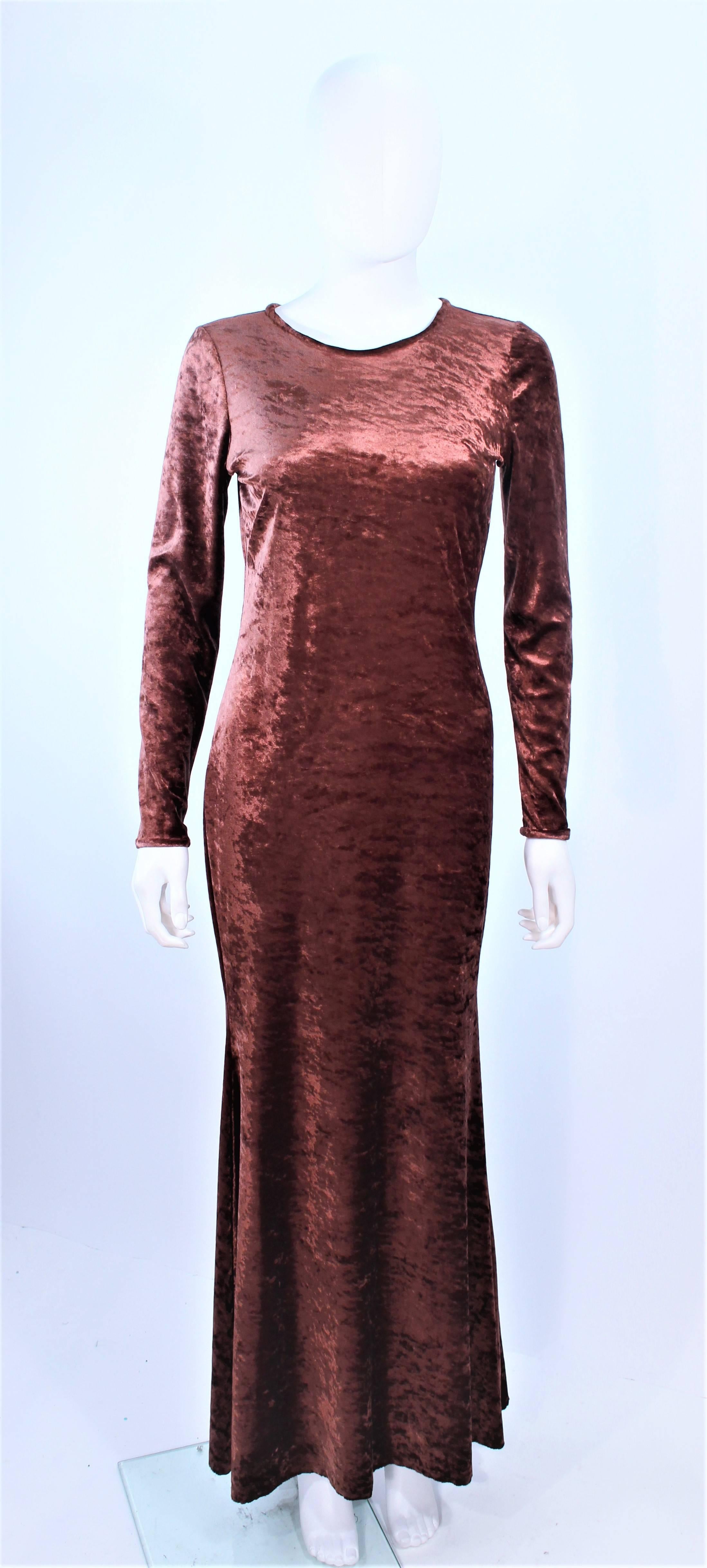 This Marly Thomas dress is composed of a bronze copper hue stretch velvet. Features a full length style with long sleeves. Pull-Over style. Sold As-Is.

**Please cross-reference measurements for personal accuracy. Size in description box is an