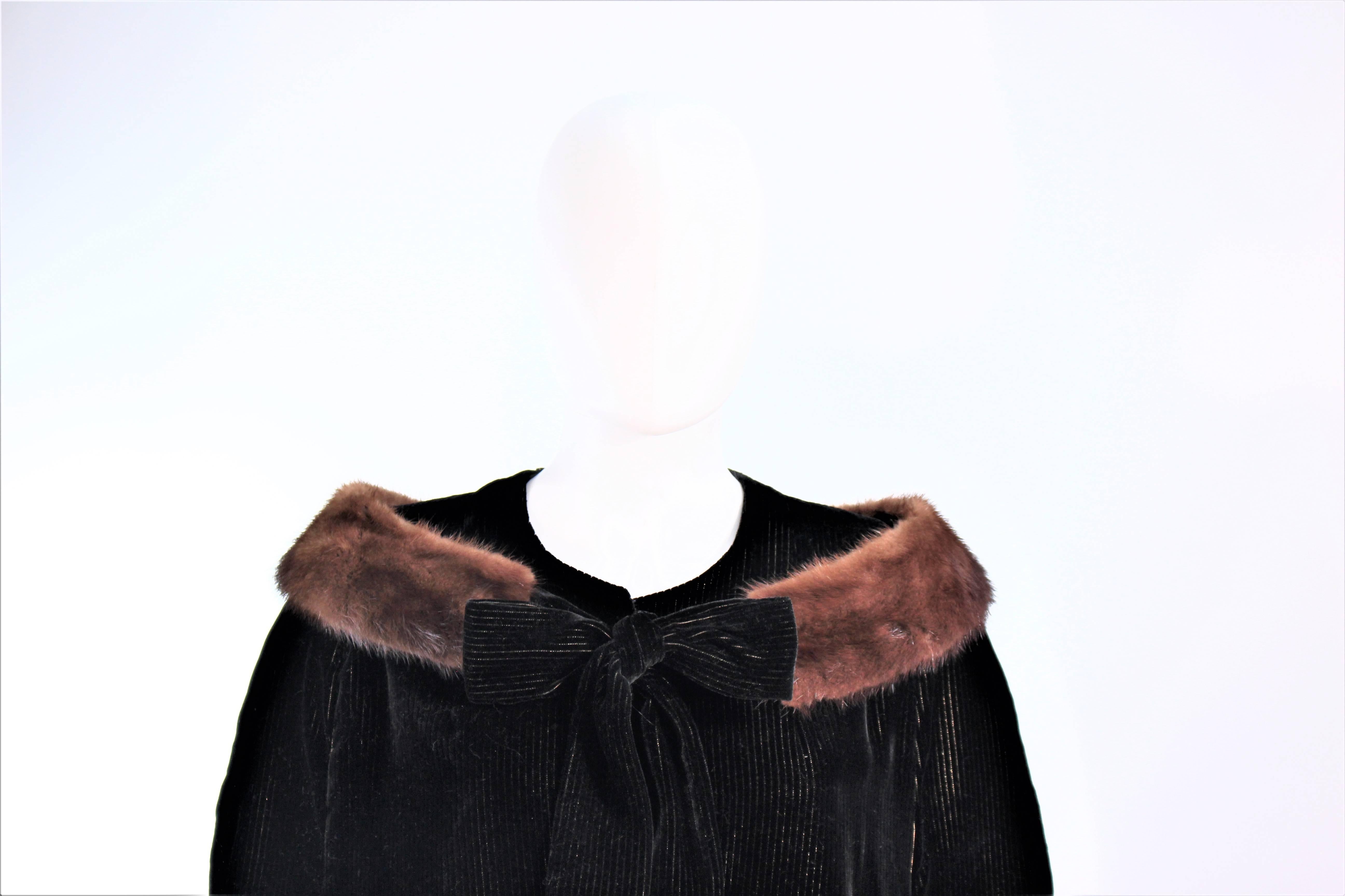 This vintage cape is composed of a black velvet with metallic pinstriping throughout. There is a center front button closure. In excellent vintage condition.

**Please cross-reference measurements for personal accuracy. Size in description box is