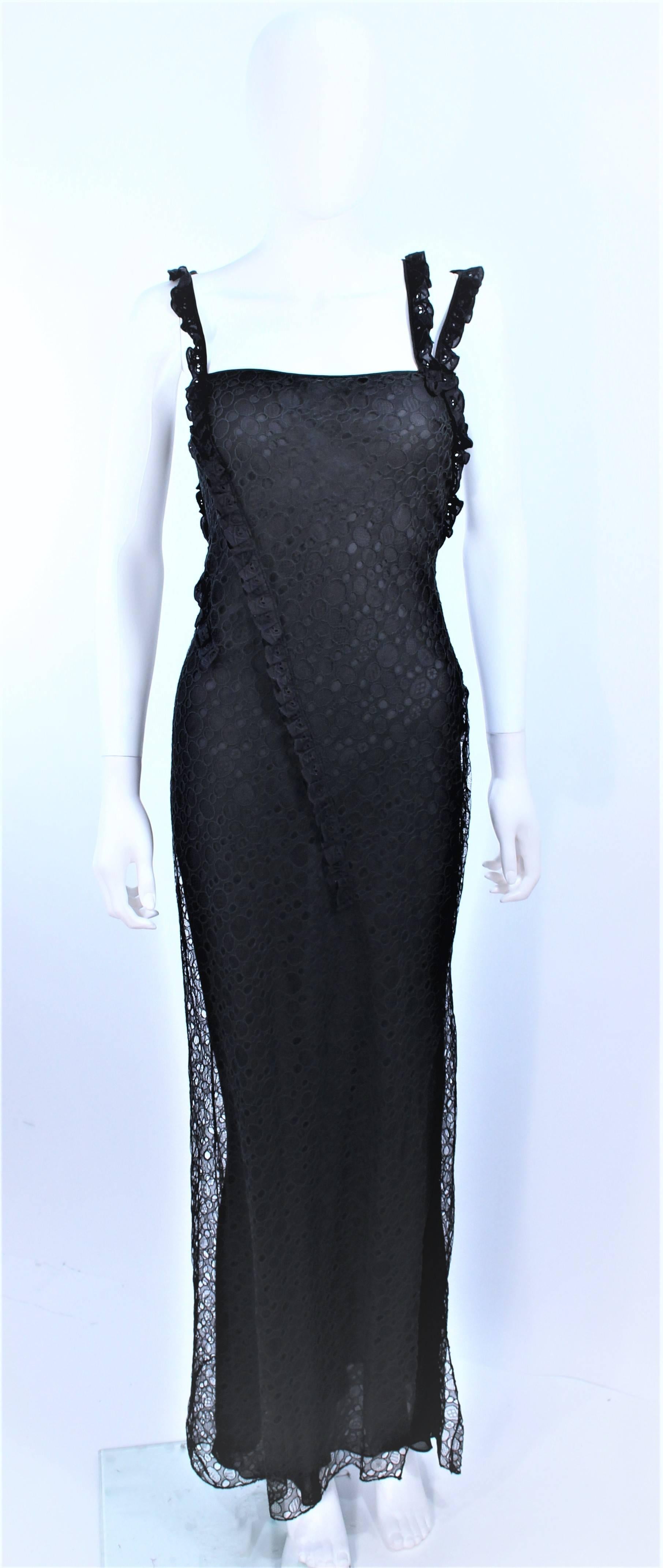 This John Galliano gown is composed of a black silk and silk eyelet lace with a bias cut design. There is a side zipper closure. In excellent pre-owned condition.

**Please cross-reference measurements for personal accuracy. Size in description