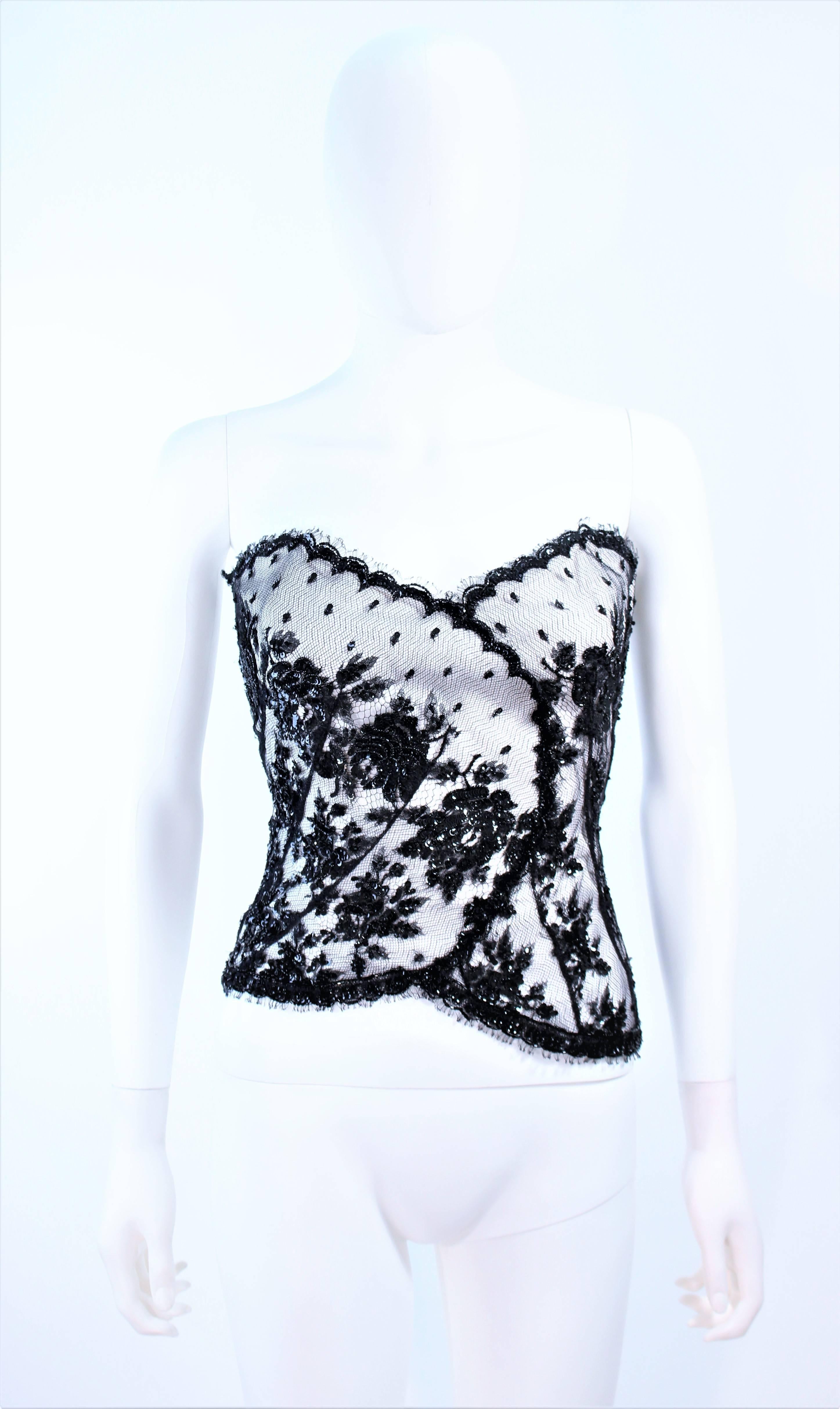 This Christina Perrin bustier is composed of a white base with black beaded lace. There is a zipper closure. Features a sweetheart neckline. In excellent pre-owned condition.

**Please cross-reference measurements for personal accuracy. Size in