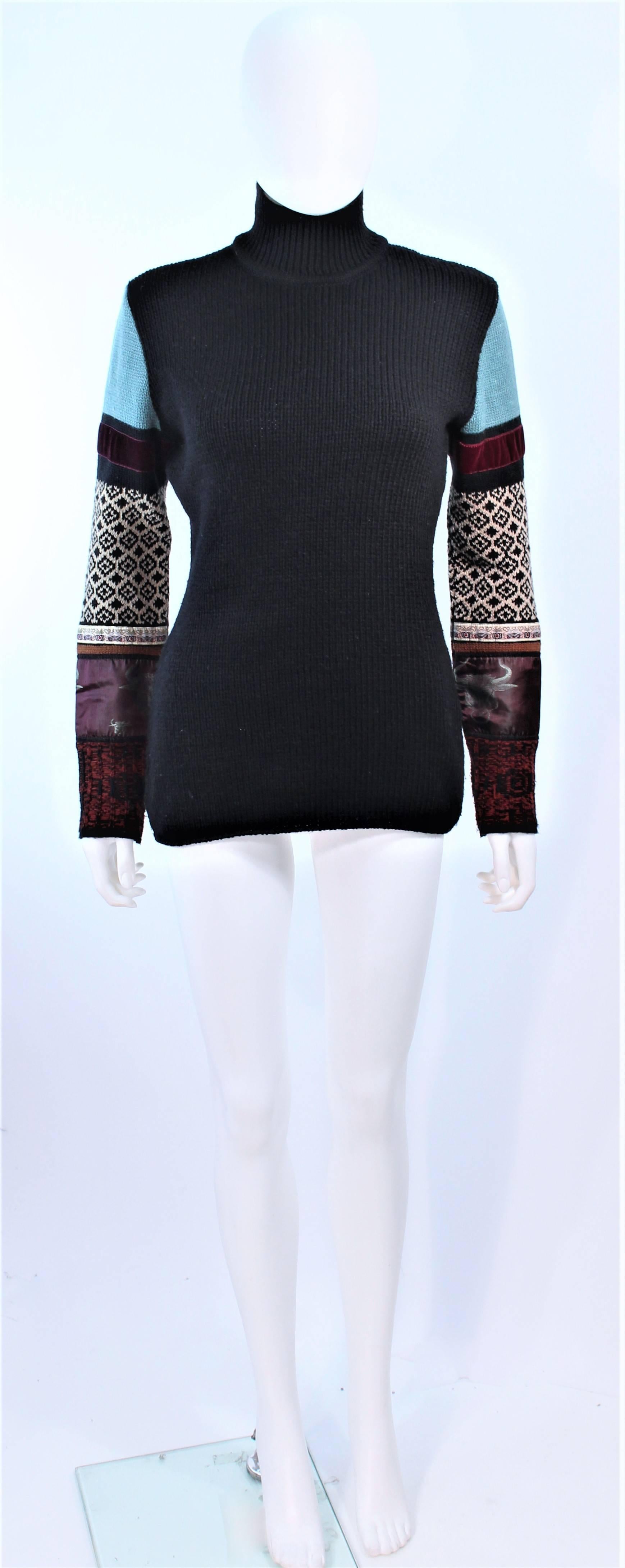 This Jean Paul Gaultier sweater is composed of a black knit with multi-applique and design. Features a turtleneck style. In excellent pre-owned condition.

**Please cross-reference measurements for personal accuracy. Size in description box is an