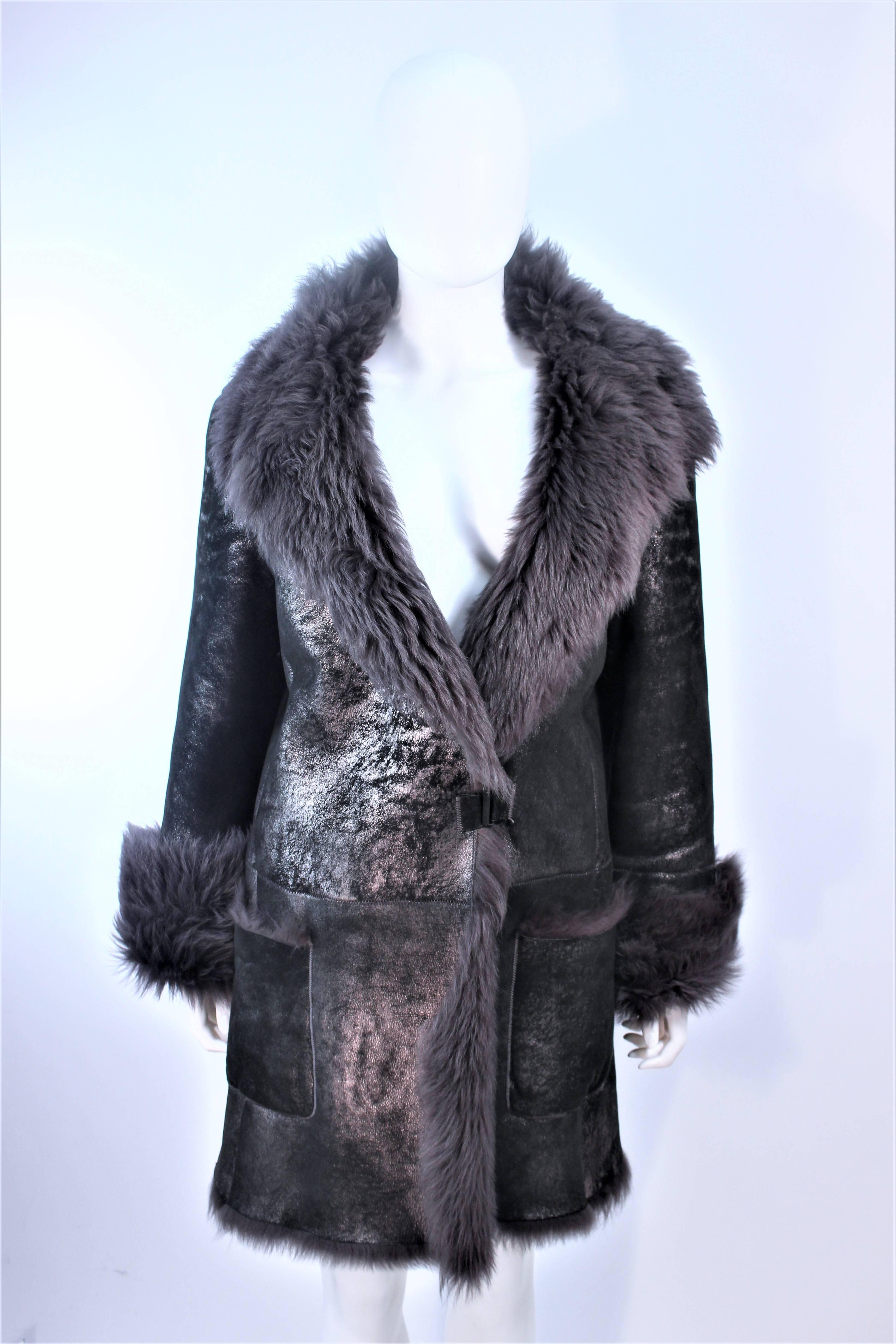 This Hugo Boss coat is composed of a grey gun metallic lambskin with fur. There are center front closures with side pockets. In excellent pre-owned condition.

**Please cross-reference measurements for personal accuracy. Size in description box is