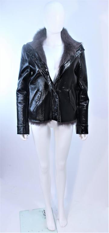 This Costume National jacket is composed of a black patent leather with grey goat fur. A stunning jacket with slight color variation in the fur and a center front zipper. In excellent pre-owned condition.

**Please cross-reference measurements for