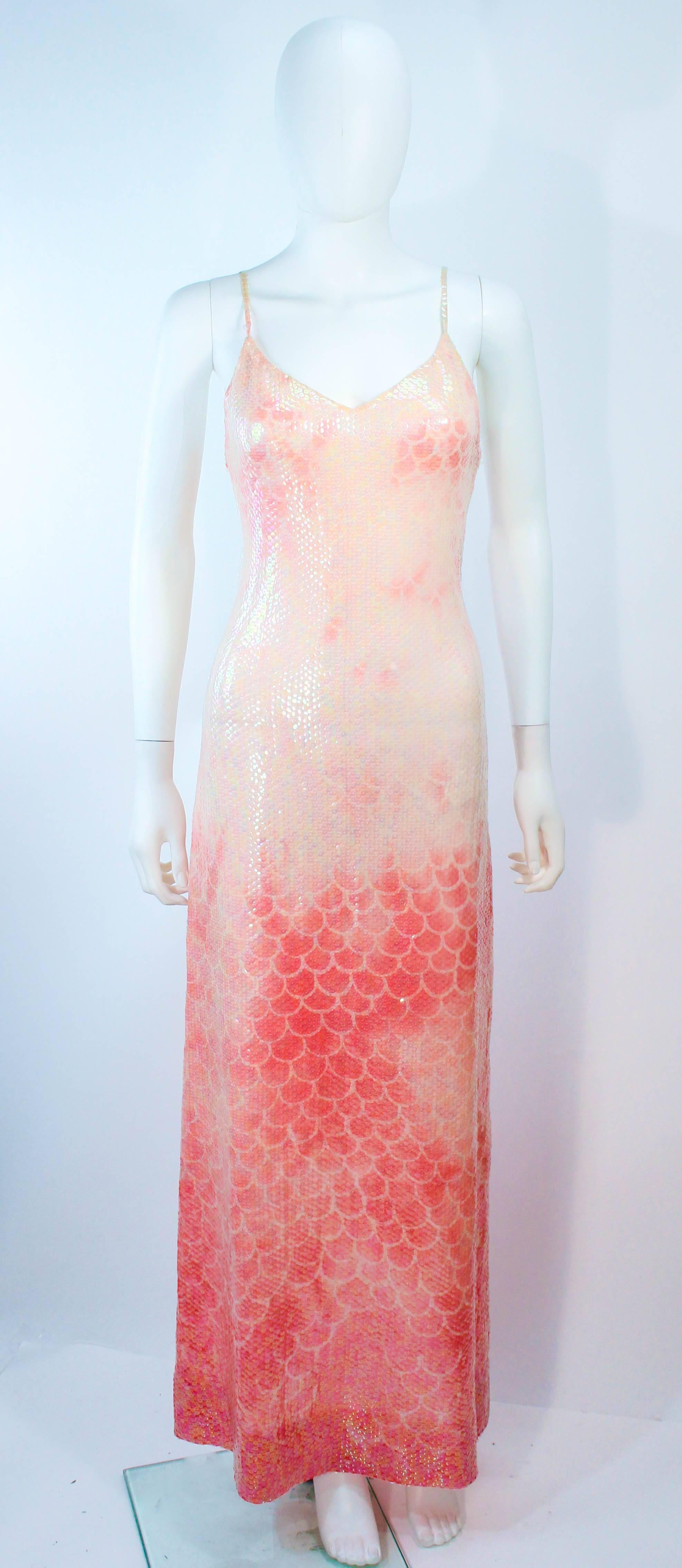 This vintage 1970's Halston gown is composed of a pink and peach hues, with sequin applique. This is a rare single owner piece, the original label was removed by the owner due to the sheerness of the gown (She may still have it and we will replace