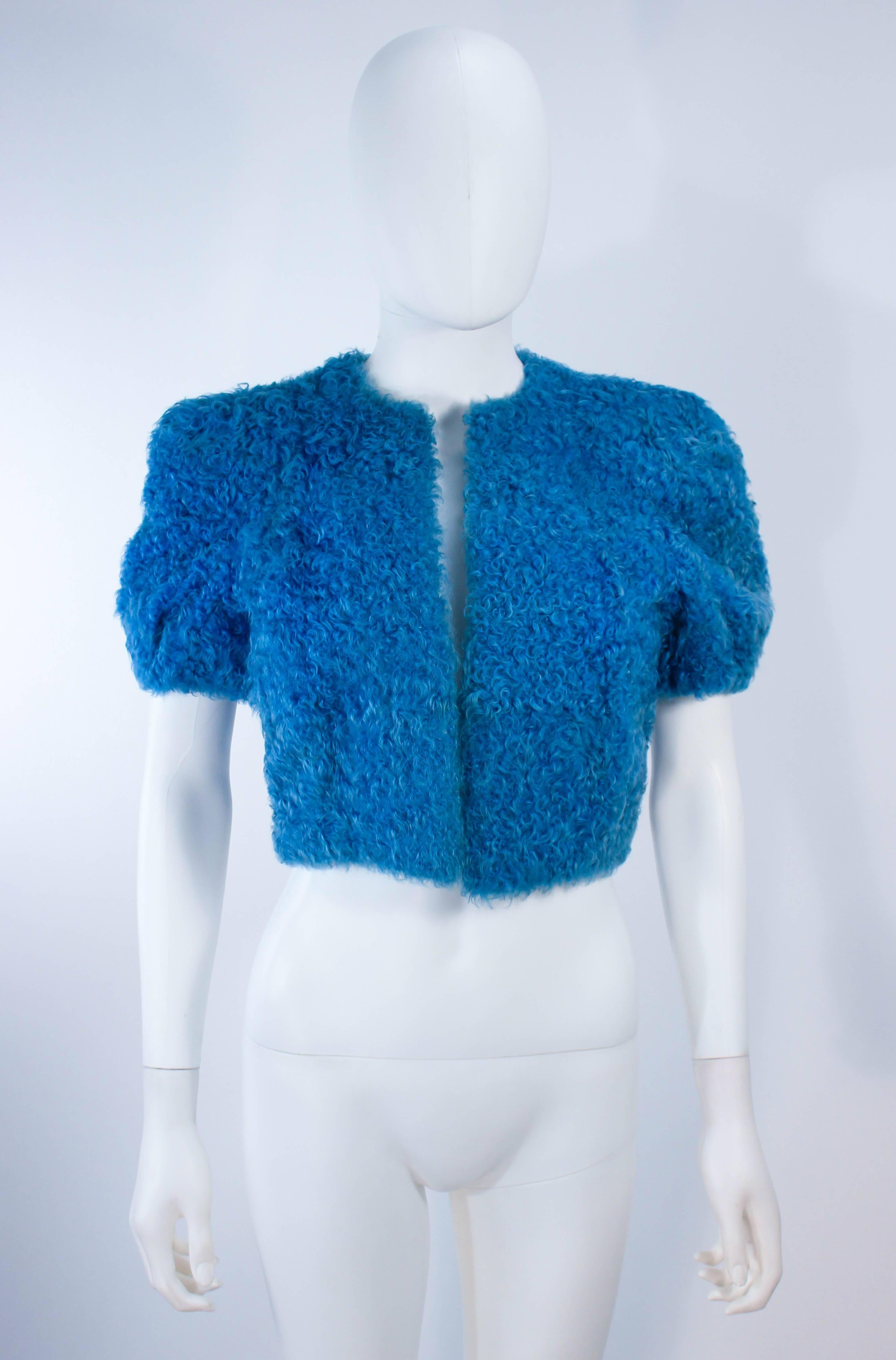 This vintage 1950's cropped jacket is composed of curly blue lamb. Features an open style with slightly puffed sleeves. In excellent vintage condition.

**Please cross-reference measurements for personal accuracy. Size in description box is an