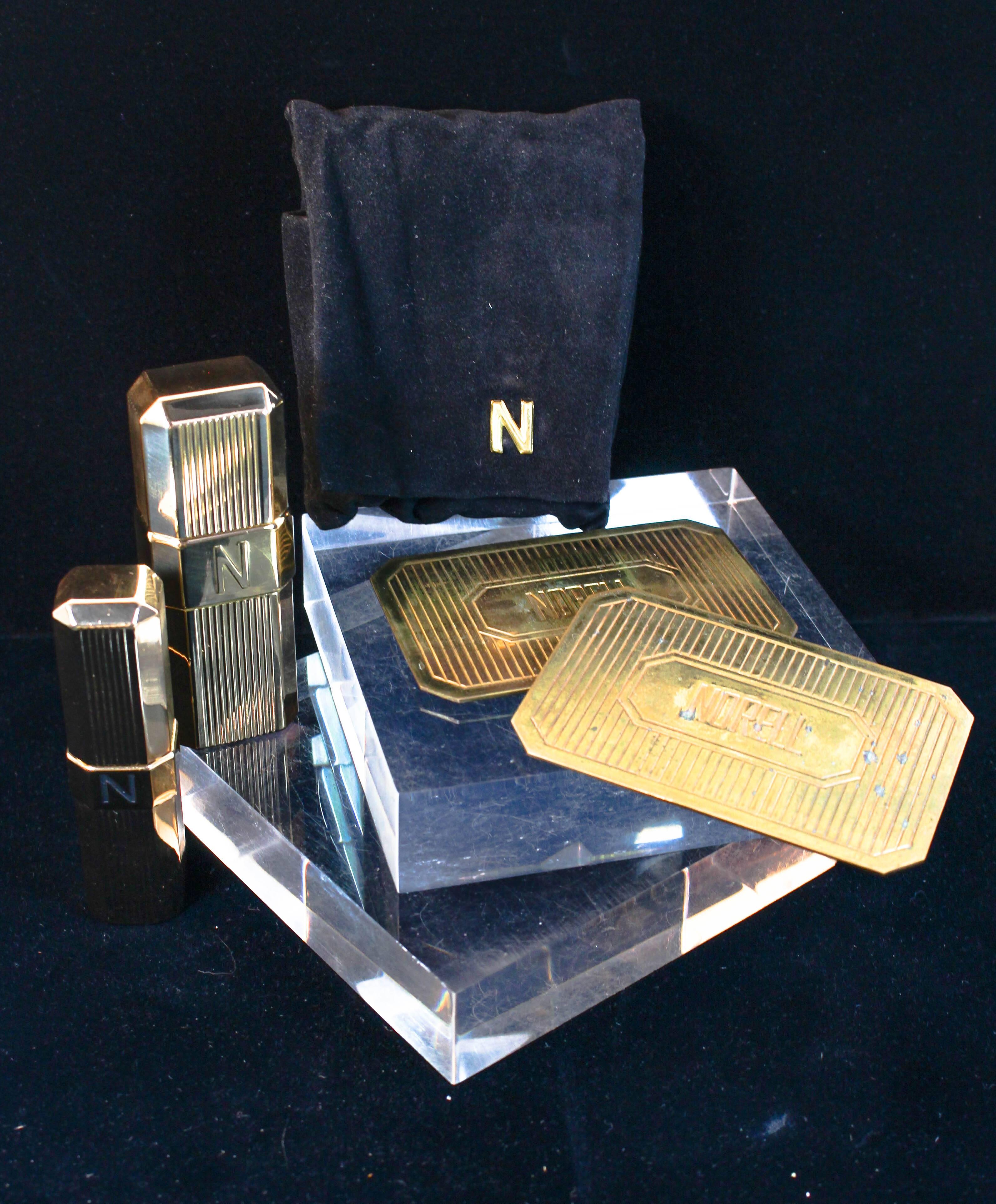 This Norman Norell set is composed of a gold tone metal. Features 