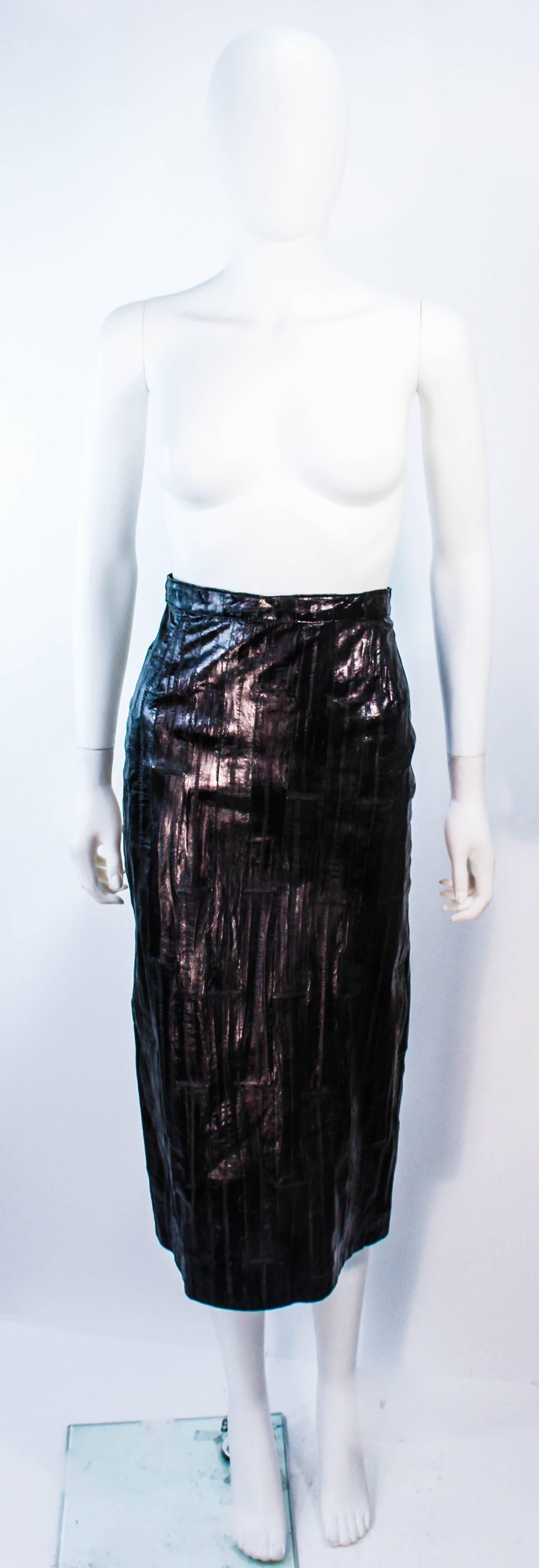This Krizia design is composed of black eel with a shine finish. Features a midi length with zipper closure. In excellent vintage condition.

**Please cross-reference measurements for personal accuracy. Size in description box is an estimation.