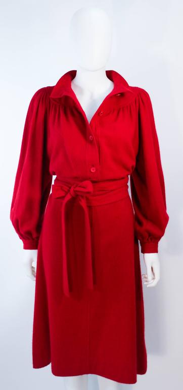This Ungaro dress is composed of a red cashmere and wool blend. Features center front button closures, billow sleeves, and waist belt. In excellent vintage condition.

**Please cross-reference measurements for personal accuracy. Size in description