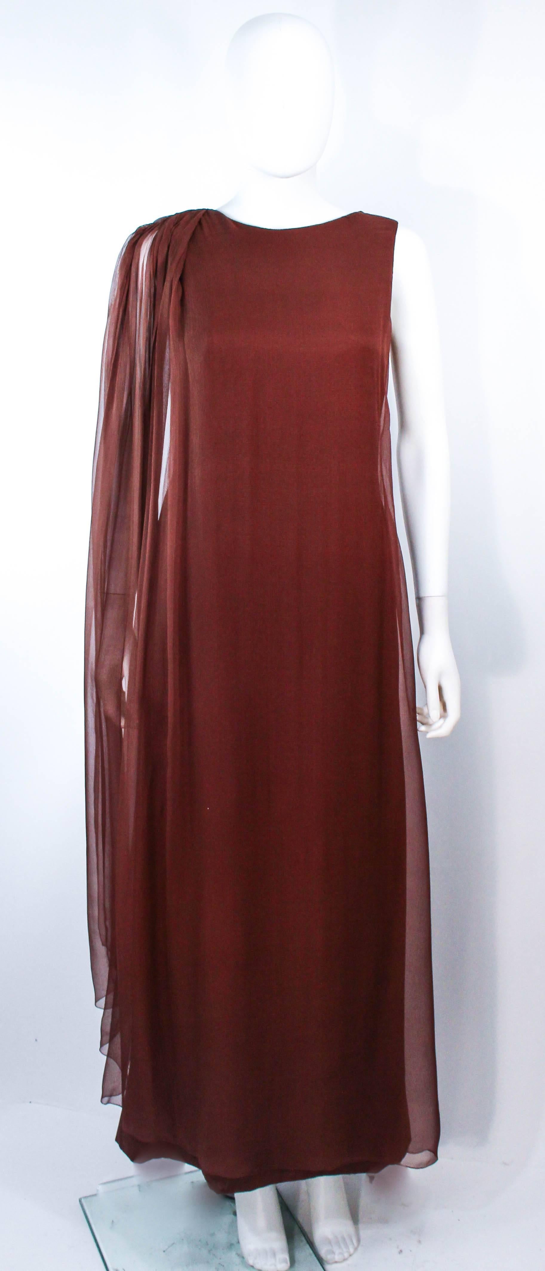 This Galanos gown is composed of a brown silk chiffon. Features a side draped style. There is a center back zipper closure. In excellent vintage condition.

**Please cross-reference measurements for personal accuracy. Size in description box is an