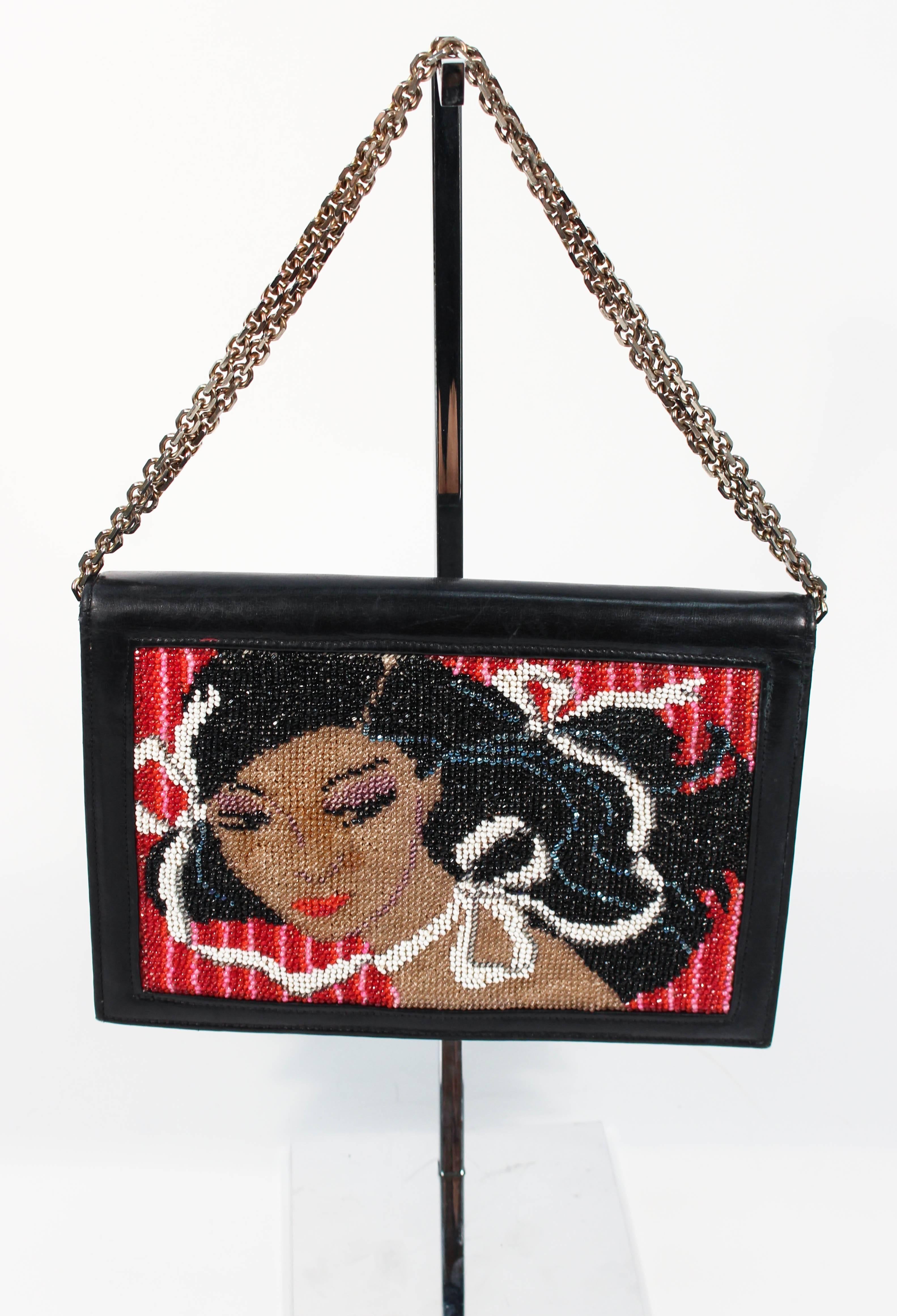 This vintage purse features a stunning beaded design with a black patent leather exterior. Features interior silk lining and an optional chain strap, which can be doubled or used single strand. The purse is in excellent condition consistent with age