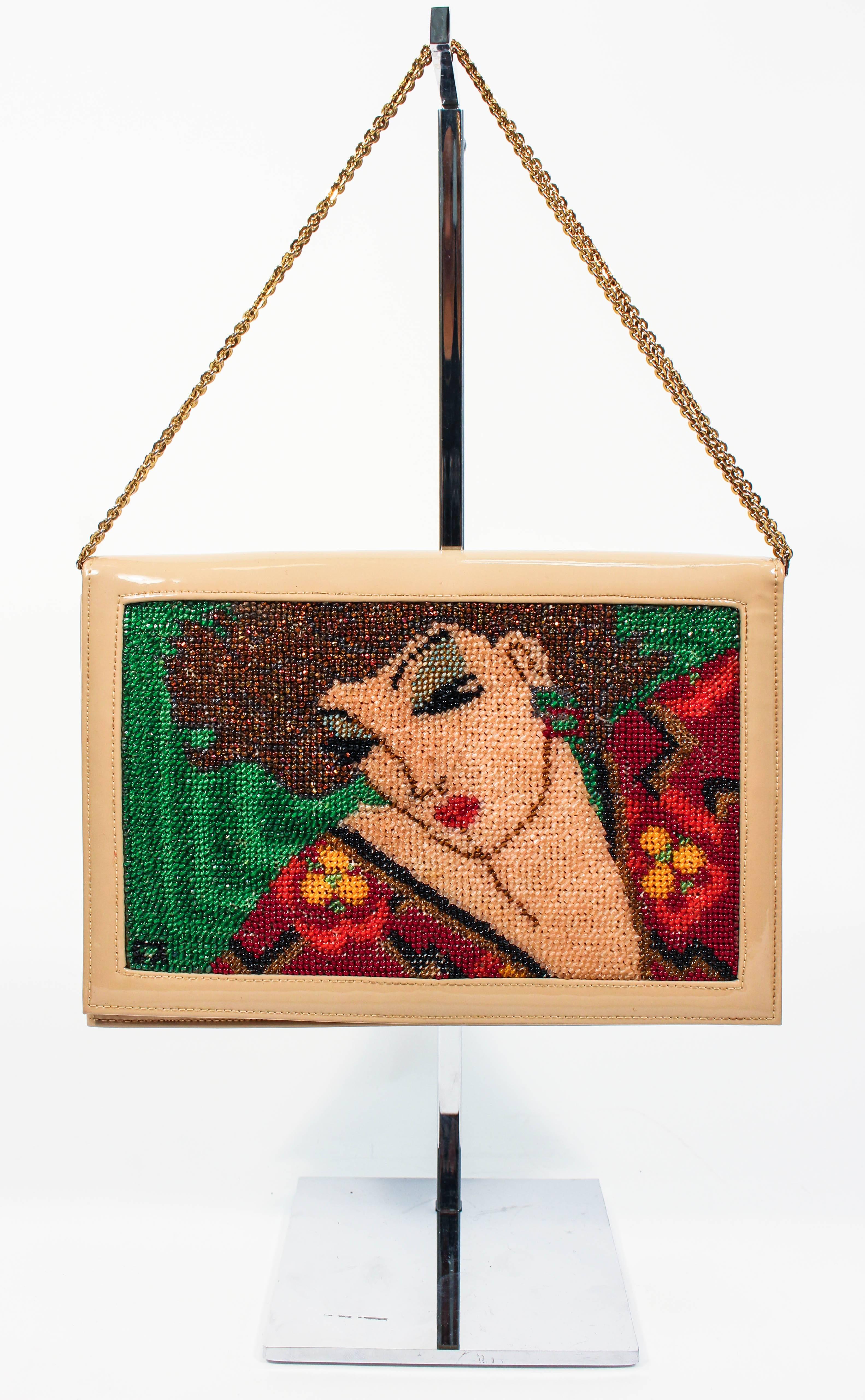This vintage purse features a stunning beaded design with a nude patent leather exterior. Features interior silk lining and an optional chain strap, which can be doubled or used single strand. The purse is in excellent interior condition consistent