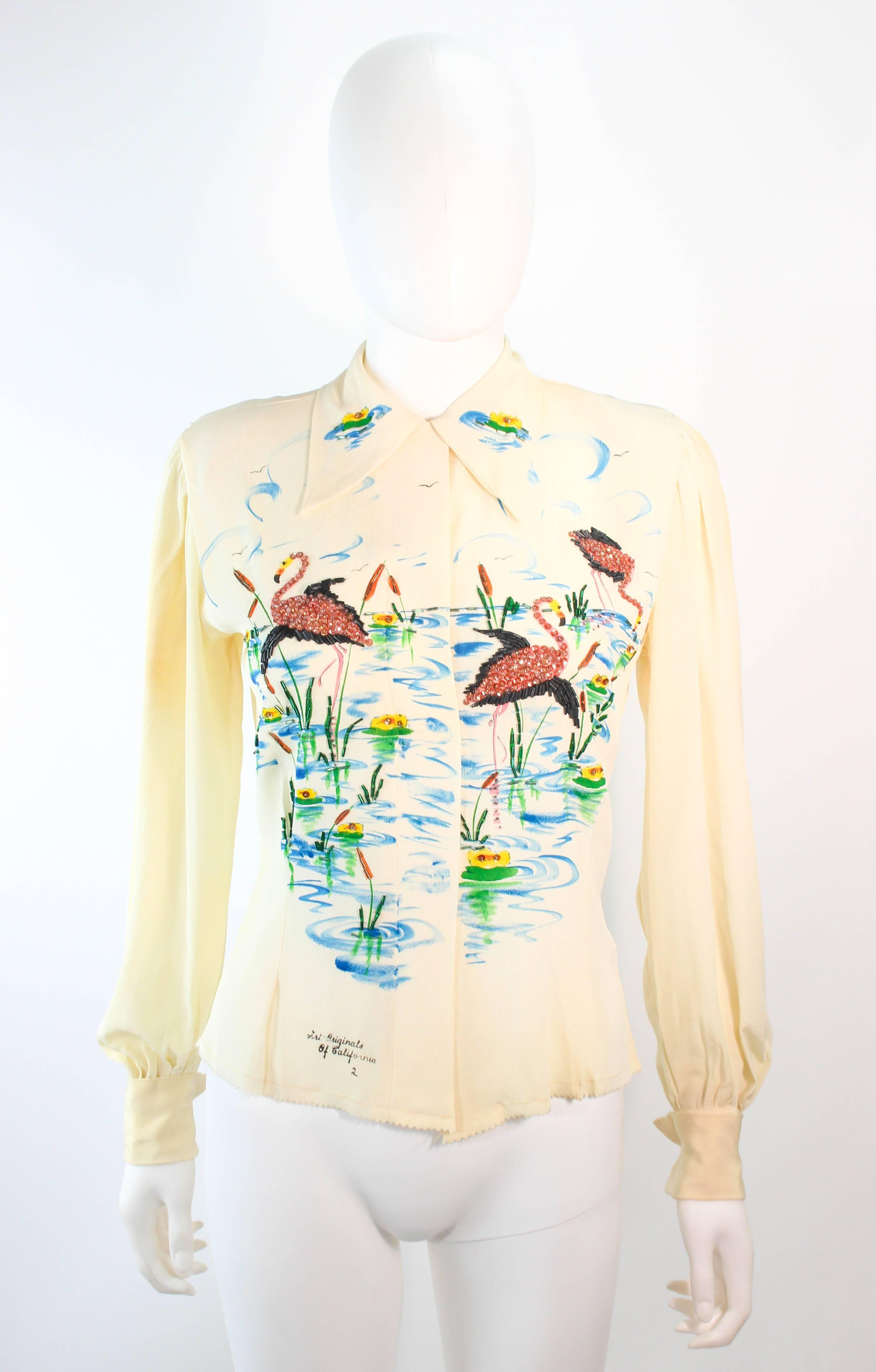 This Art Originals of California blouse is composed of an ivory silk. Features a hand painted design with beaded applique and classic collar. There are center front button closures. In great vintage condition, excellent fr design purposes, there is