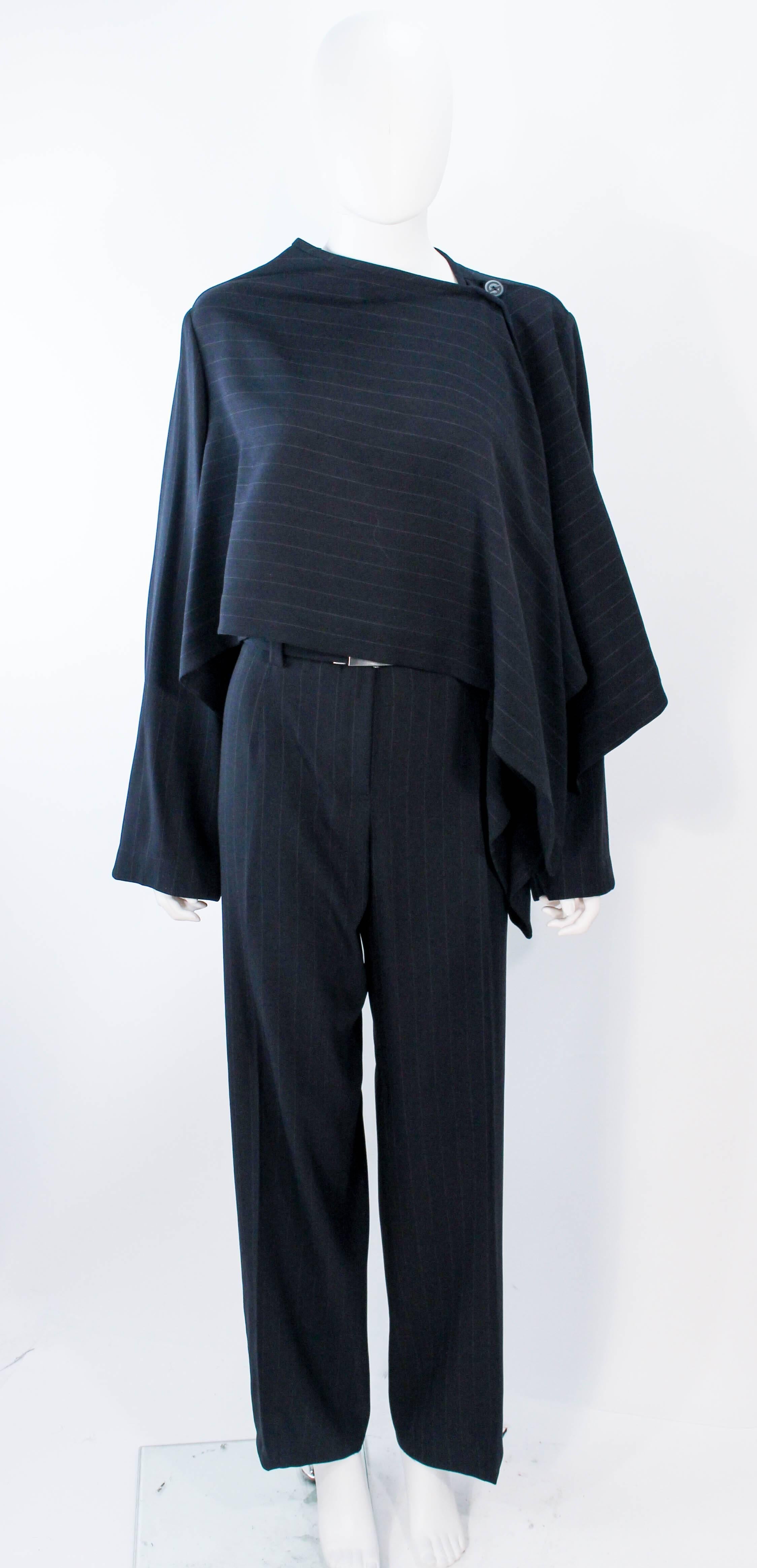 This Giorgio Armani suit is composed of a black pinstripe. Features a stunning draped style jacket. The pants have a zipper closure. In excellent condition. 

**Please cross-reference measurements for personal accuracy. Size in description box is an