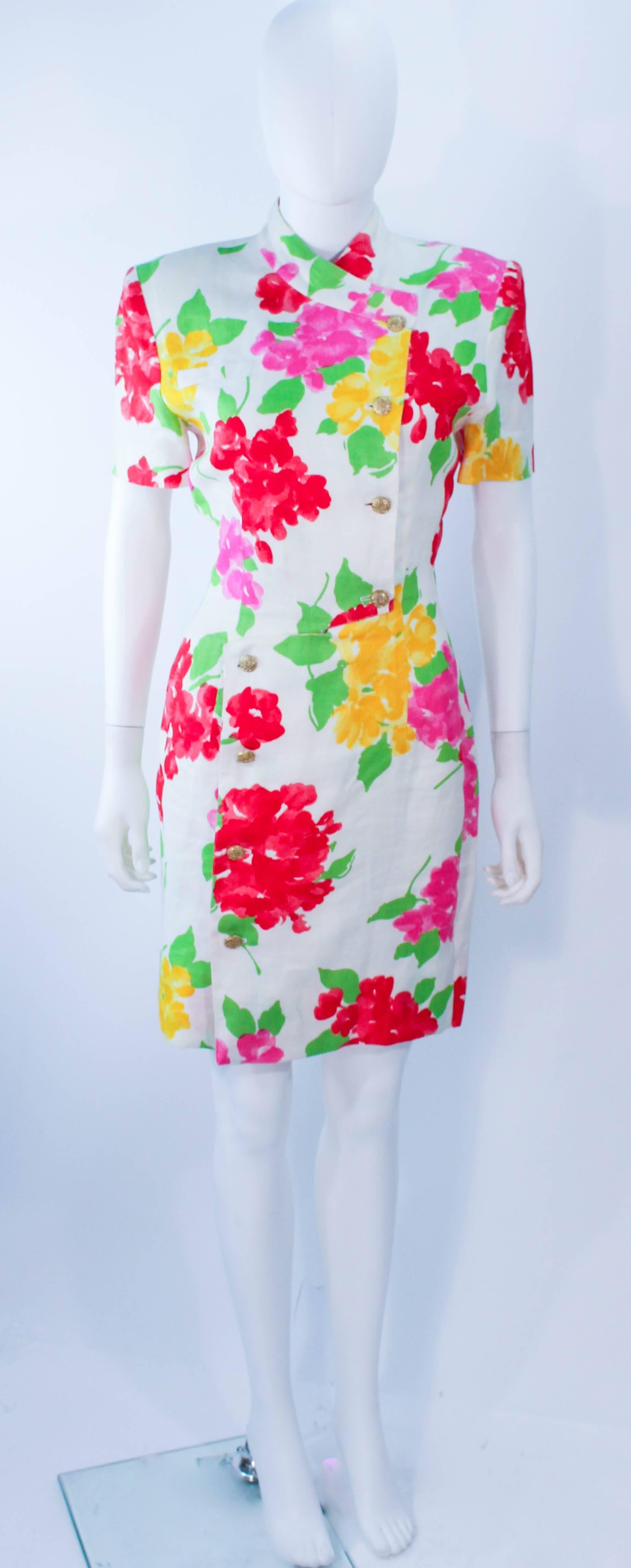 This Hanae Mori design is composed of a white linen with a colorful floral pattern. Features gold center front buttons with snaps. In excellent vintage condition with slight signs of age. 

**Please cross-reference measurements for personal