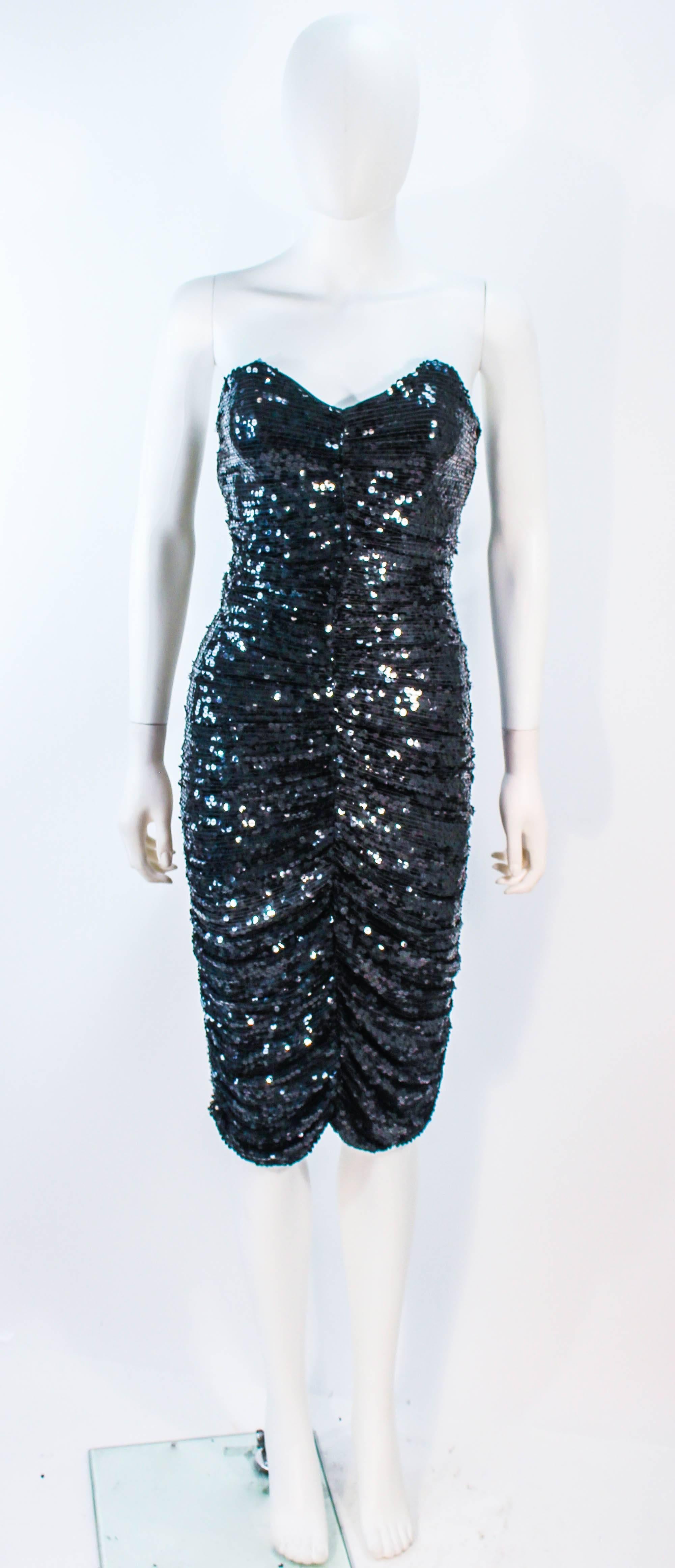 This Kozo vintage cocktail dress is composed of black silk with sequins. Features a sharp bust line and a ruched style with a center back zipper. In excellent condition. 

**Please cross-reference measurements for personal accuracy. Size in