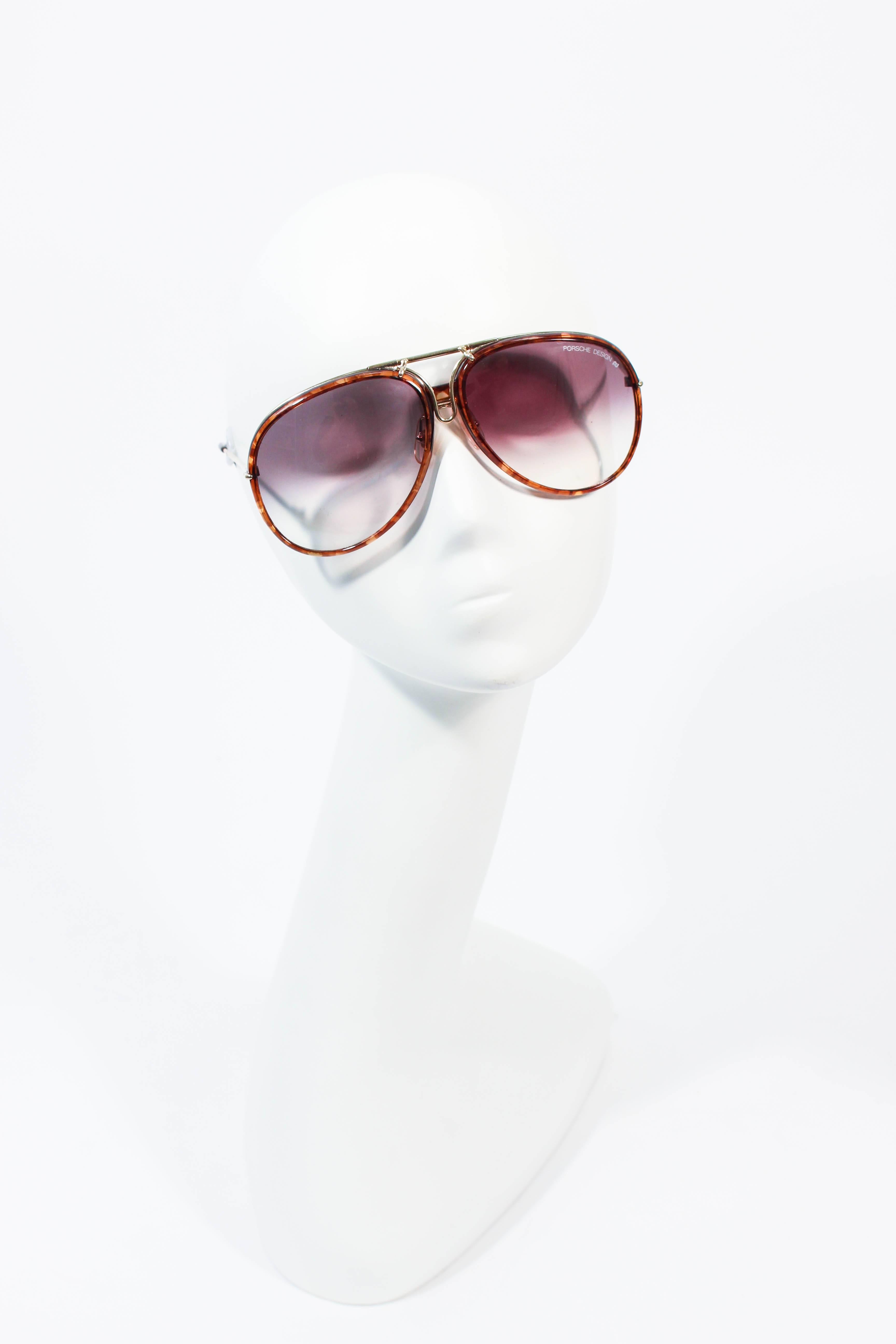 These Porsche Carrera sunglasses are composed of gold tone metal with a interchangeable brown frame. In great vintage condition, lenses are in great condition. Comes with grey case.

**Please cross-reference measurements for personal accuracy. Size