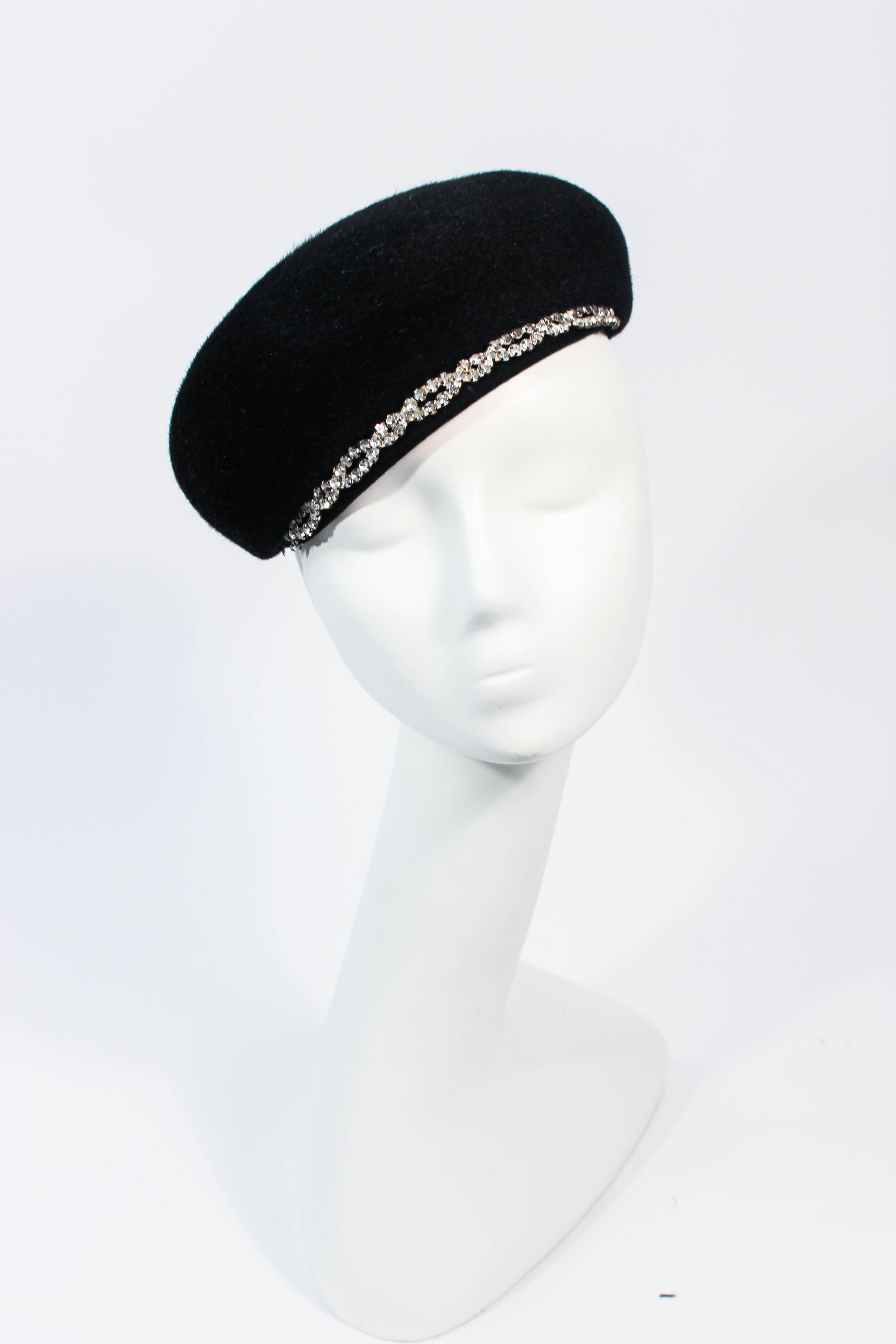 This Schiaparelli design is composed of a black fabric and features a rhinestone trim with two hat pins. Can be styled in a multitude of fashions, an amazing design. In excellent vintage condition.

**Please cross-reference measurements for personal