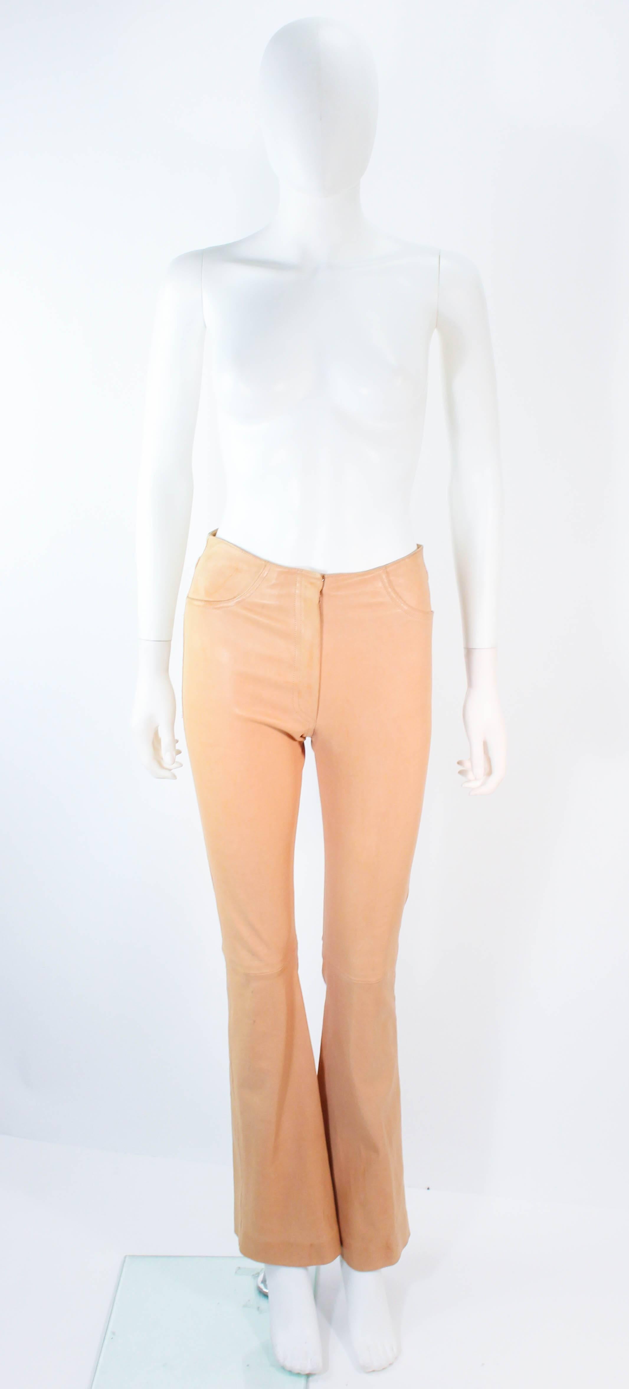 These Jean Claude Jitrois pants are composed of a beautiful stretch leather in a light natural beige hue. Features a boot cut style with a center front zipper. In excellent condition, minimal signs of wear due to the nature of the leather.