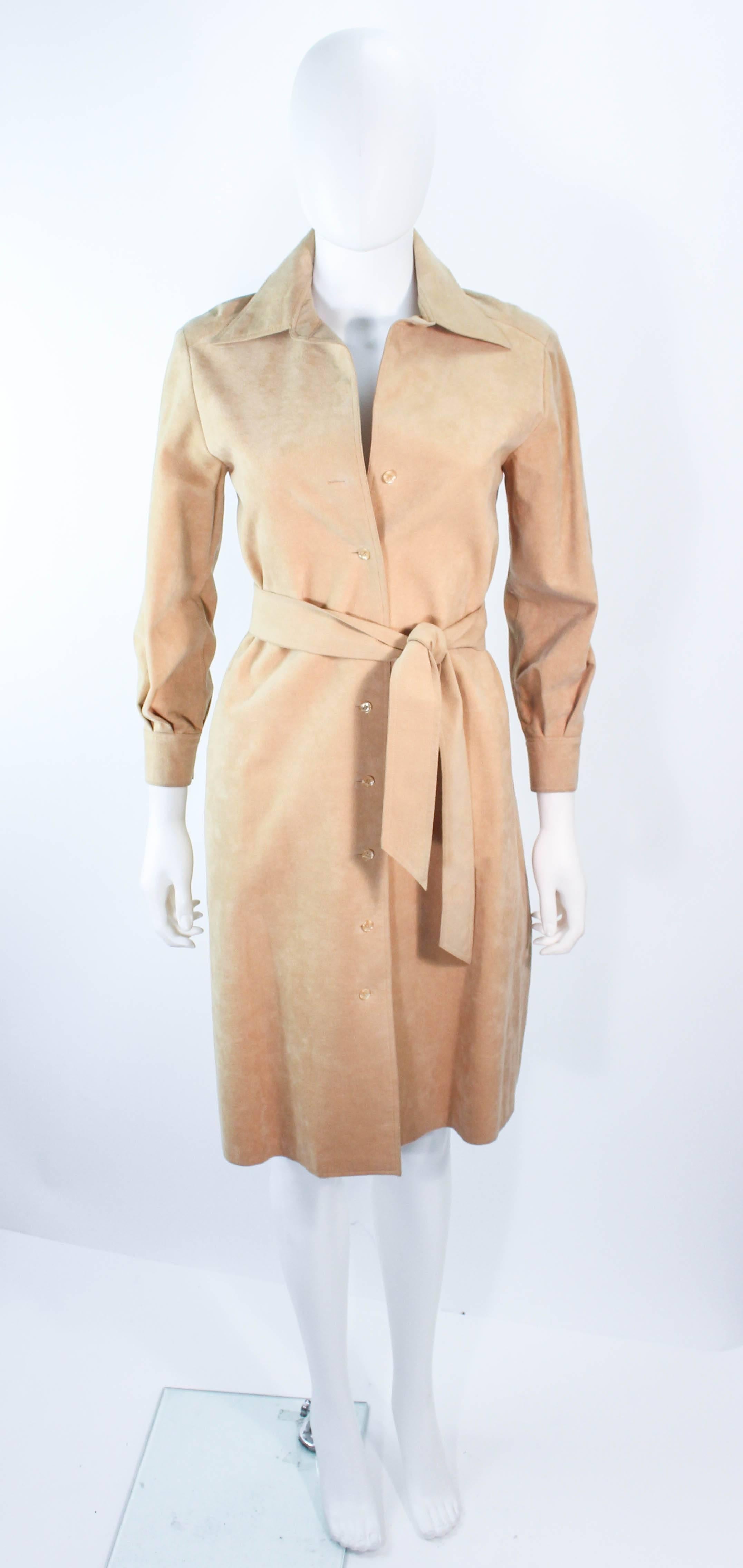 This vintage Halston design is composed of a very supple nude suede. Features center front button closures with a waist belt, and side pockets. Can be styled as a coat or a dress. In excellent condition, minimal signs of wear. 

**Please