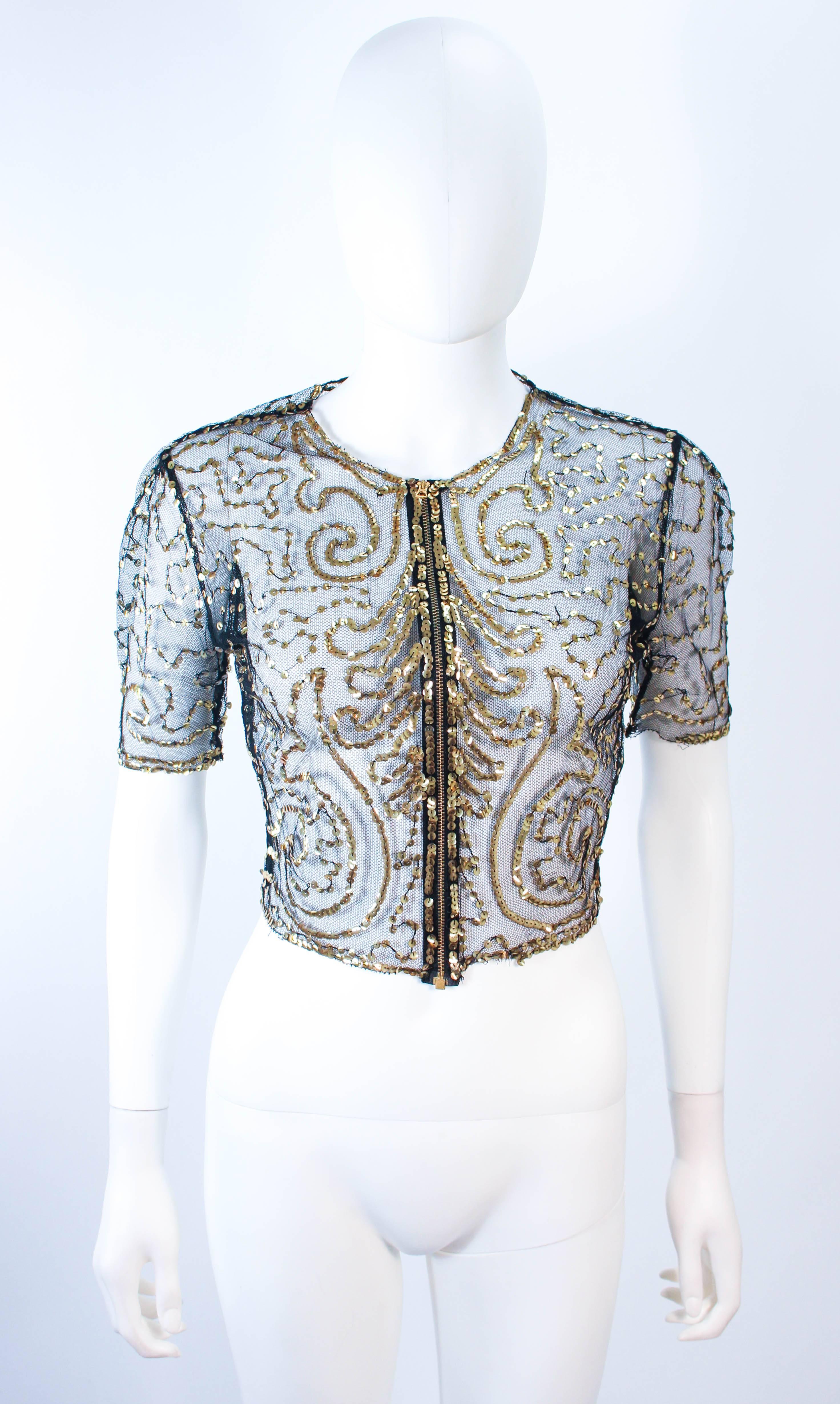 This antique jacket is composed of a sheer black mesh with gold sequin applique. Features a 3/4 sleeve. There is a center front zipper closure. In excellent vintage condition. 

**Please cross-reference measurements for personal accuracy. Size in
