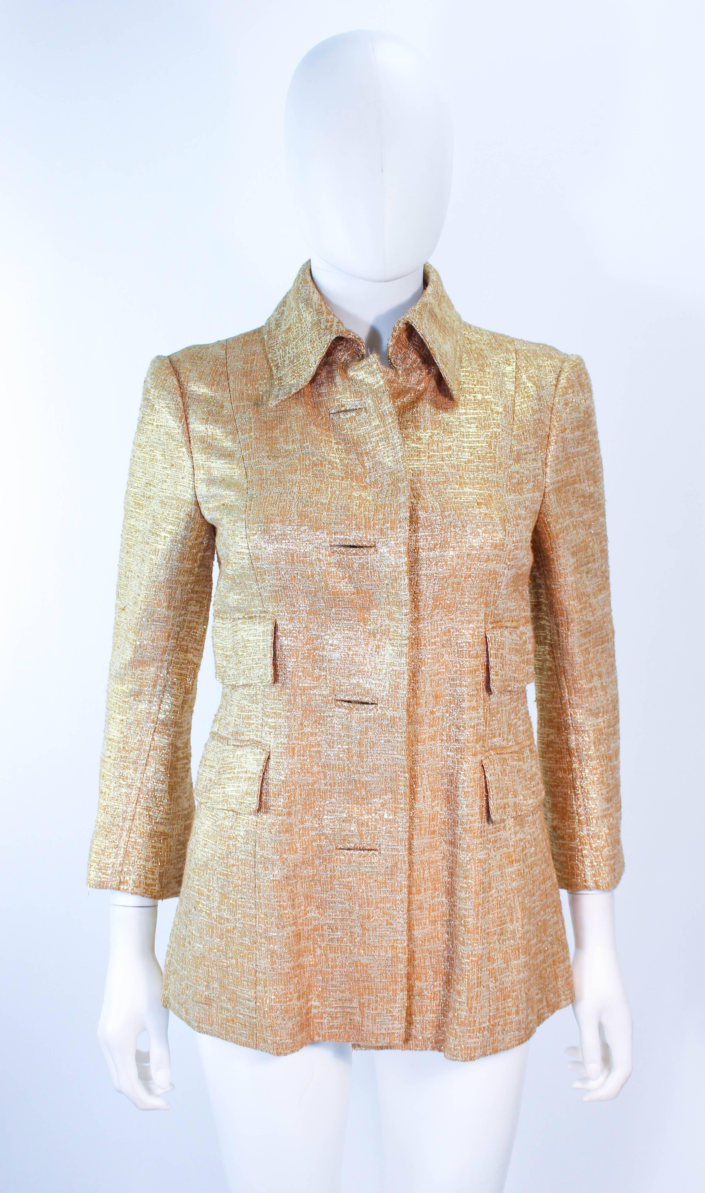 This Dolce and Gabbana jacket is composed of a gold metallic fabric Features center front snap buttons with a faux accent. There are front pockets. In excellent pre-condition.

**Please cross-reference measurements for personal accuracy. Size in