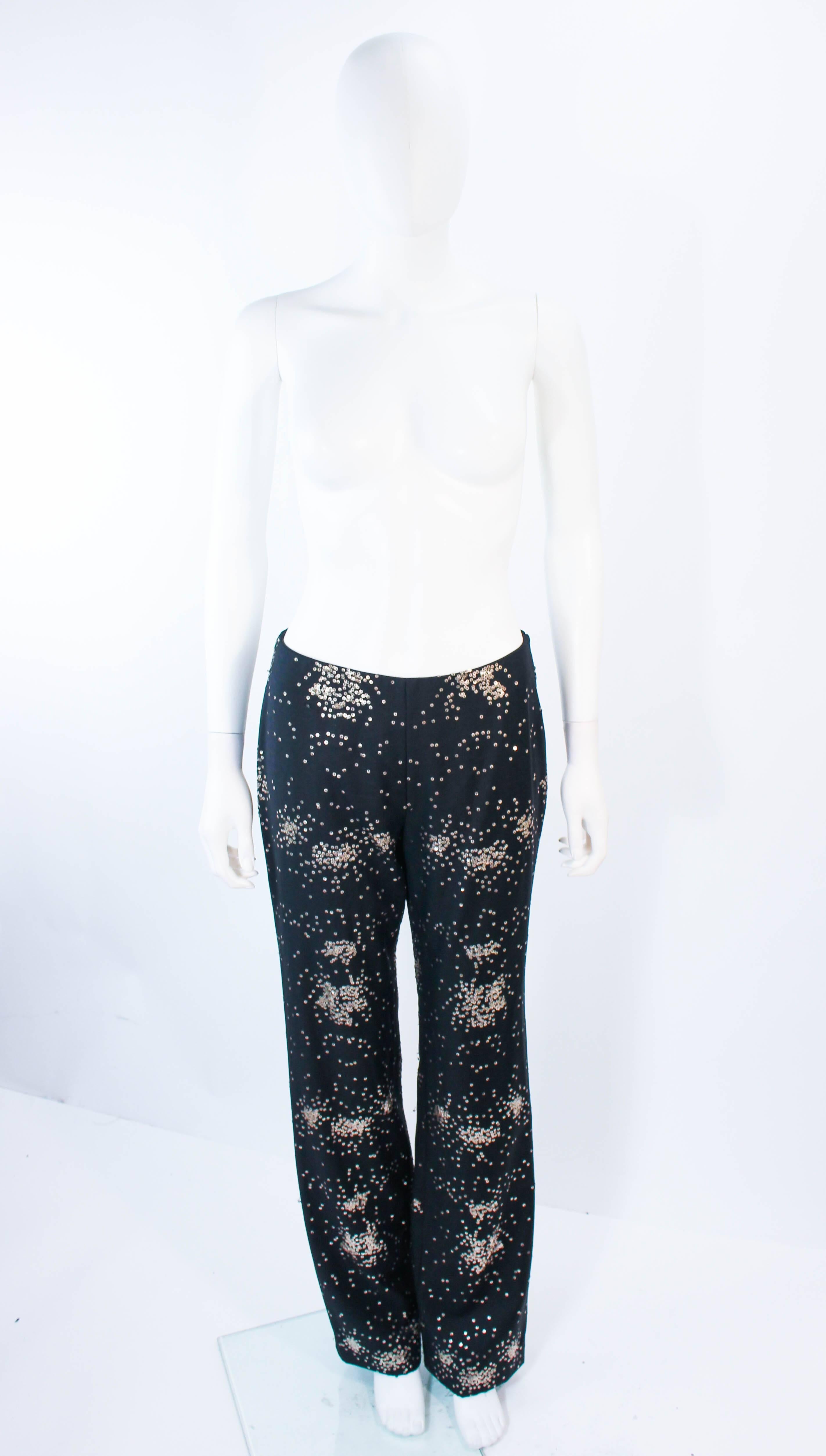 These Ozbek pants are composed of a black fabric with metal sequin applique. Feature a bootleg flare style with a side zipper closure. In excellent vintage condition.

**Please cross-reference measurements for personal accuracy. Size in description