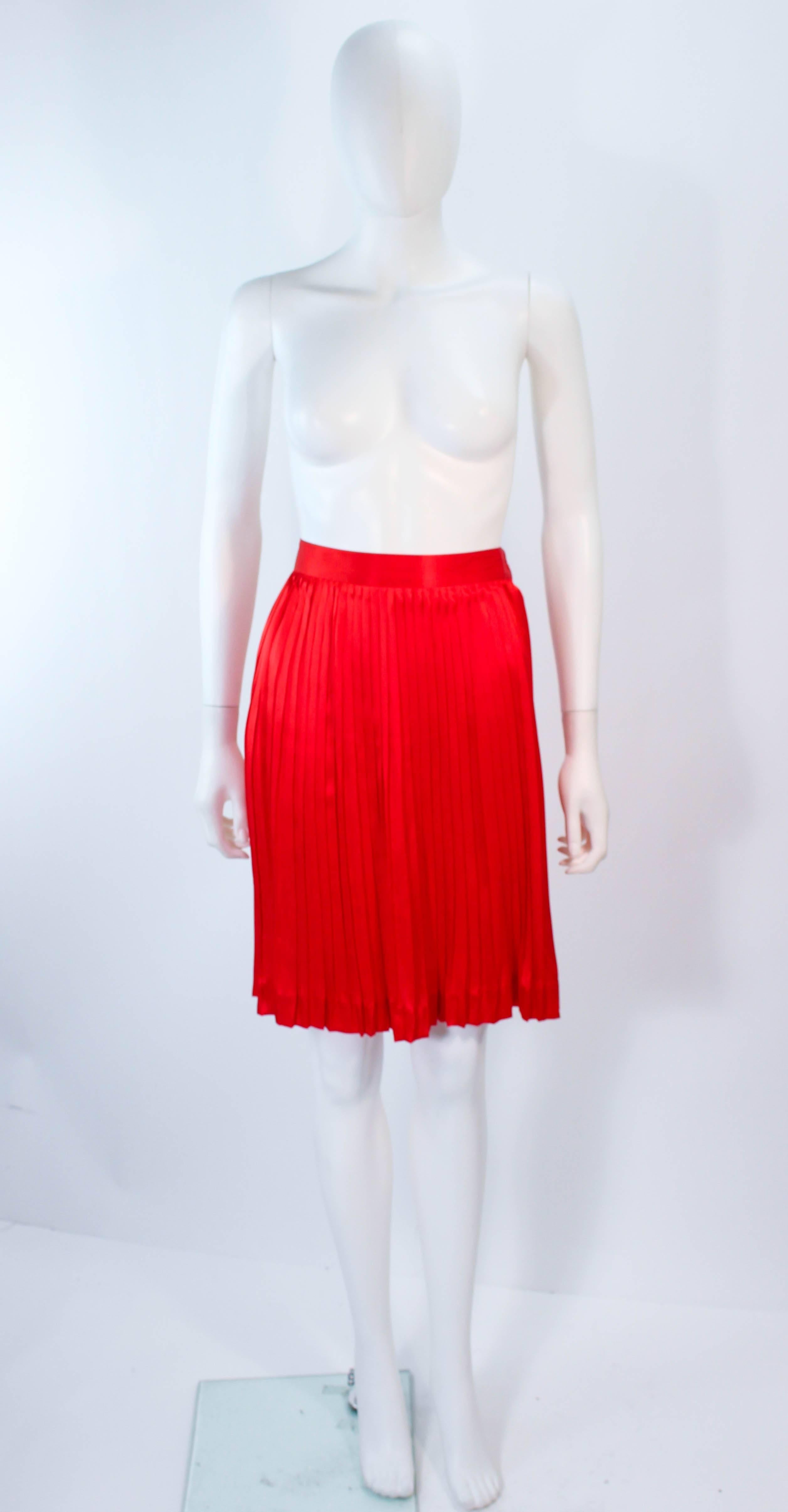 This Christian Dior skirt is composed of a red silk and features a pleated design. There is a side zipper closure. In excellent vintage condition.

**Please cross-reference measurements for personal accuracy. Size in description box is an