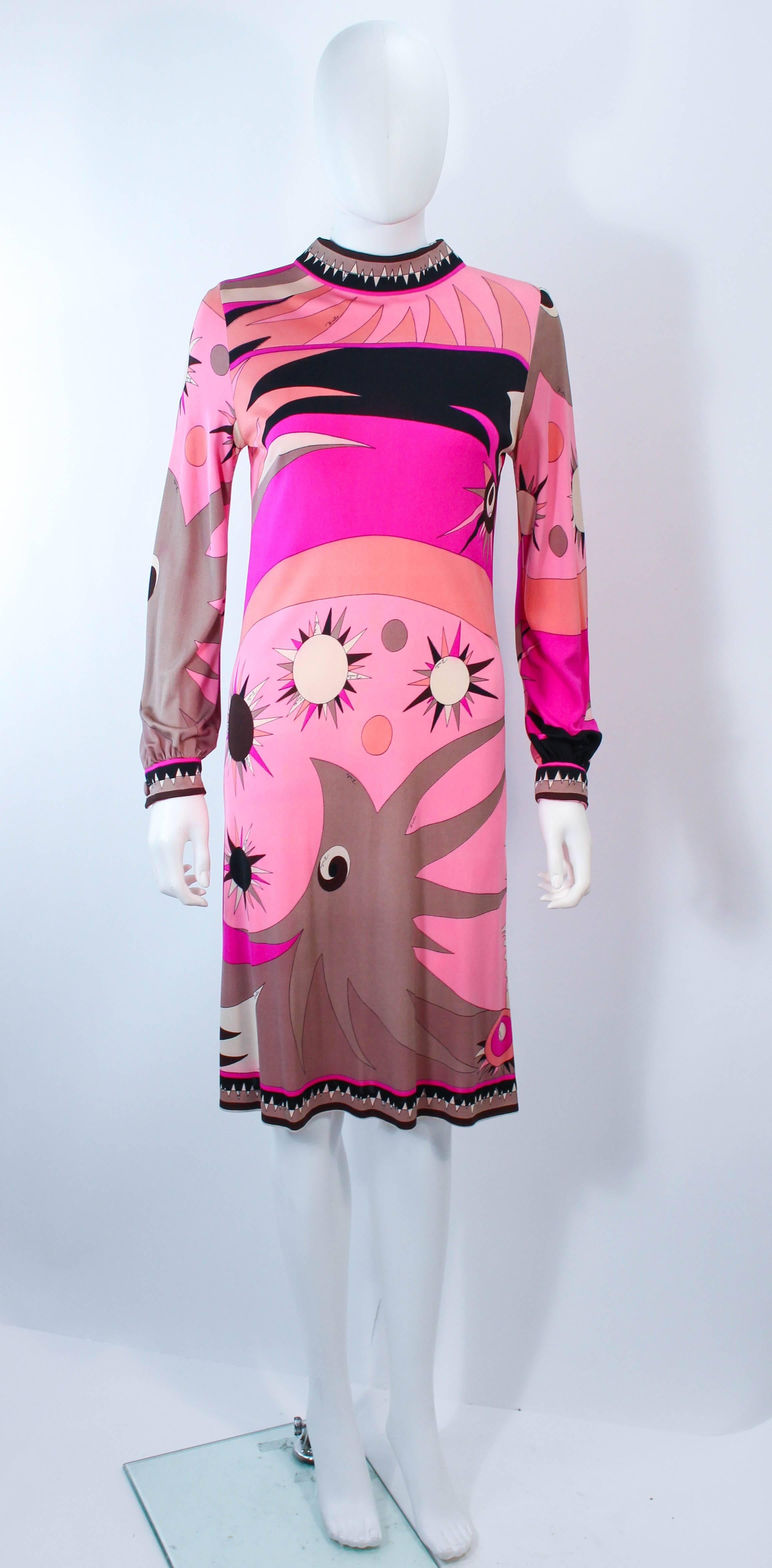 This Emilio Pucci dress is composed of a pick and black combination stretch silk with a classic abstract Pucci print. There is a side zipper closure. In great vintage condition, excellent for a collector or design research. Sold 'AS IS' there is