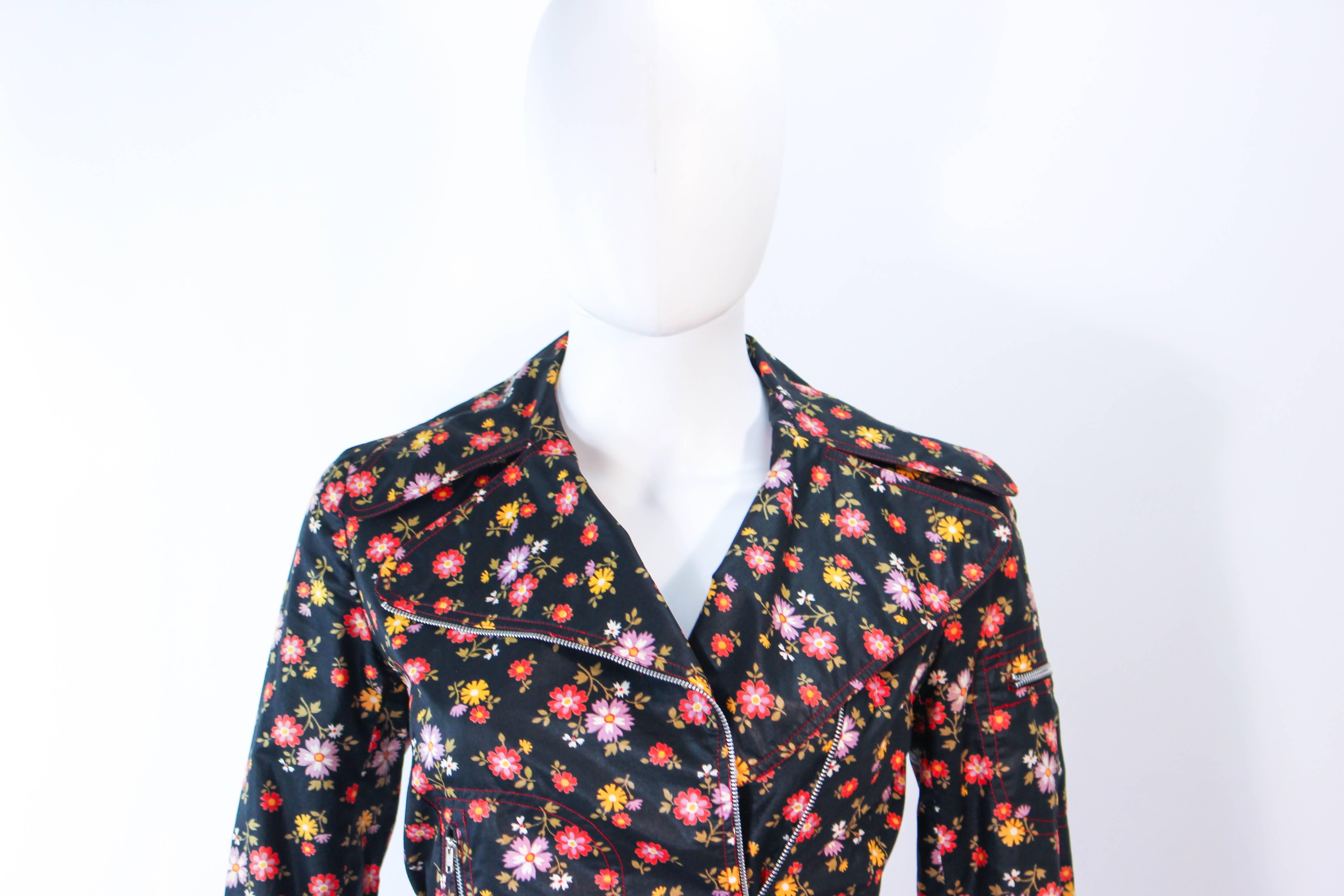 This Joseph Magin set is composed of a floral print waxed cotton. The jacket features an asymmetrical zipper closure with zippers at the pockets and sleeves. The pants have a classic slack style with zipper closure. In excellent vintage