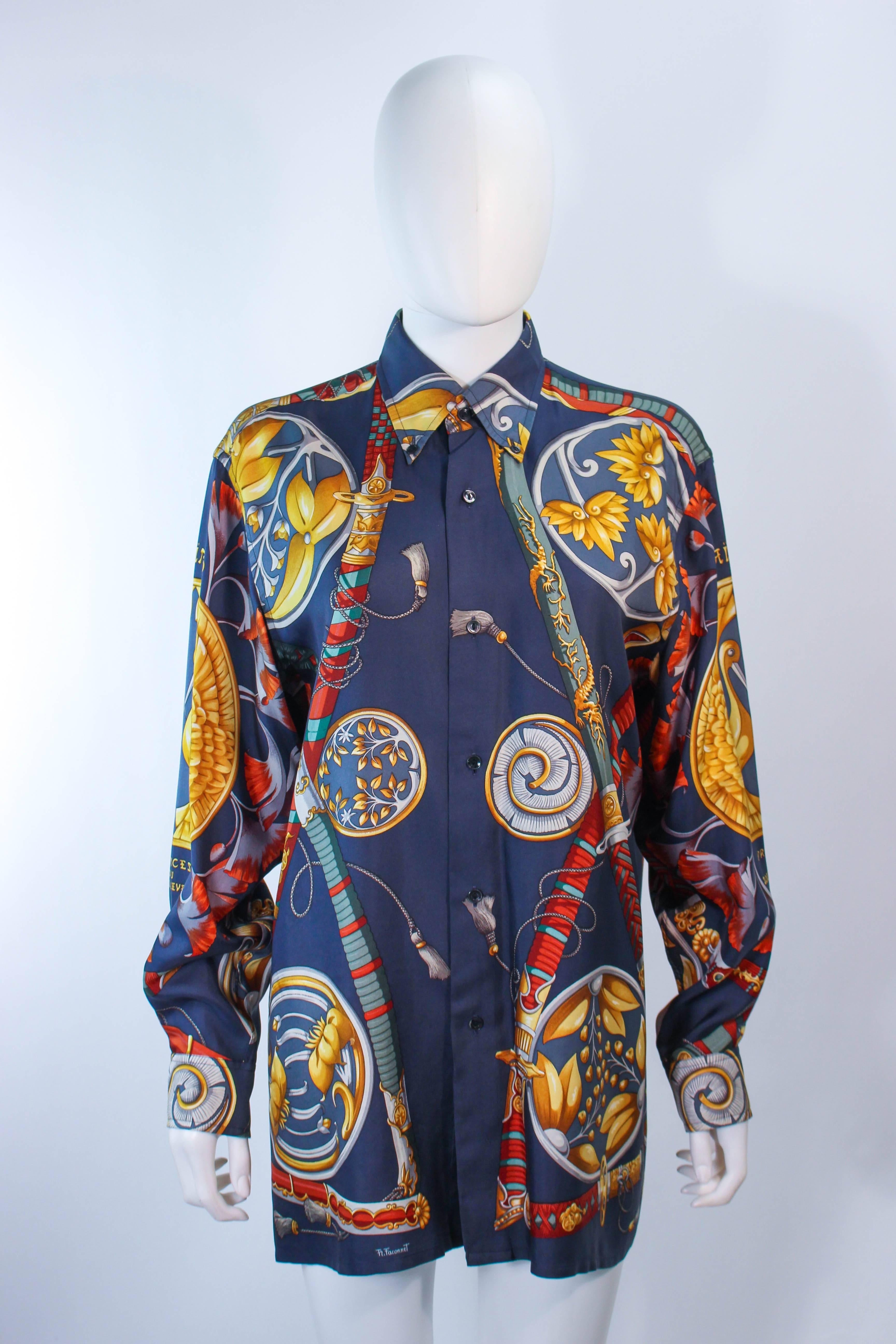 This Hermes shirt is composed of a blue silk and features a sword pattern. Features center front button closures. Can be worn by men or women. In excellent vintage condition.

**Please cross-reference measurements for personal accuracy. Size in