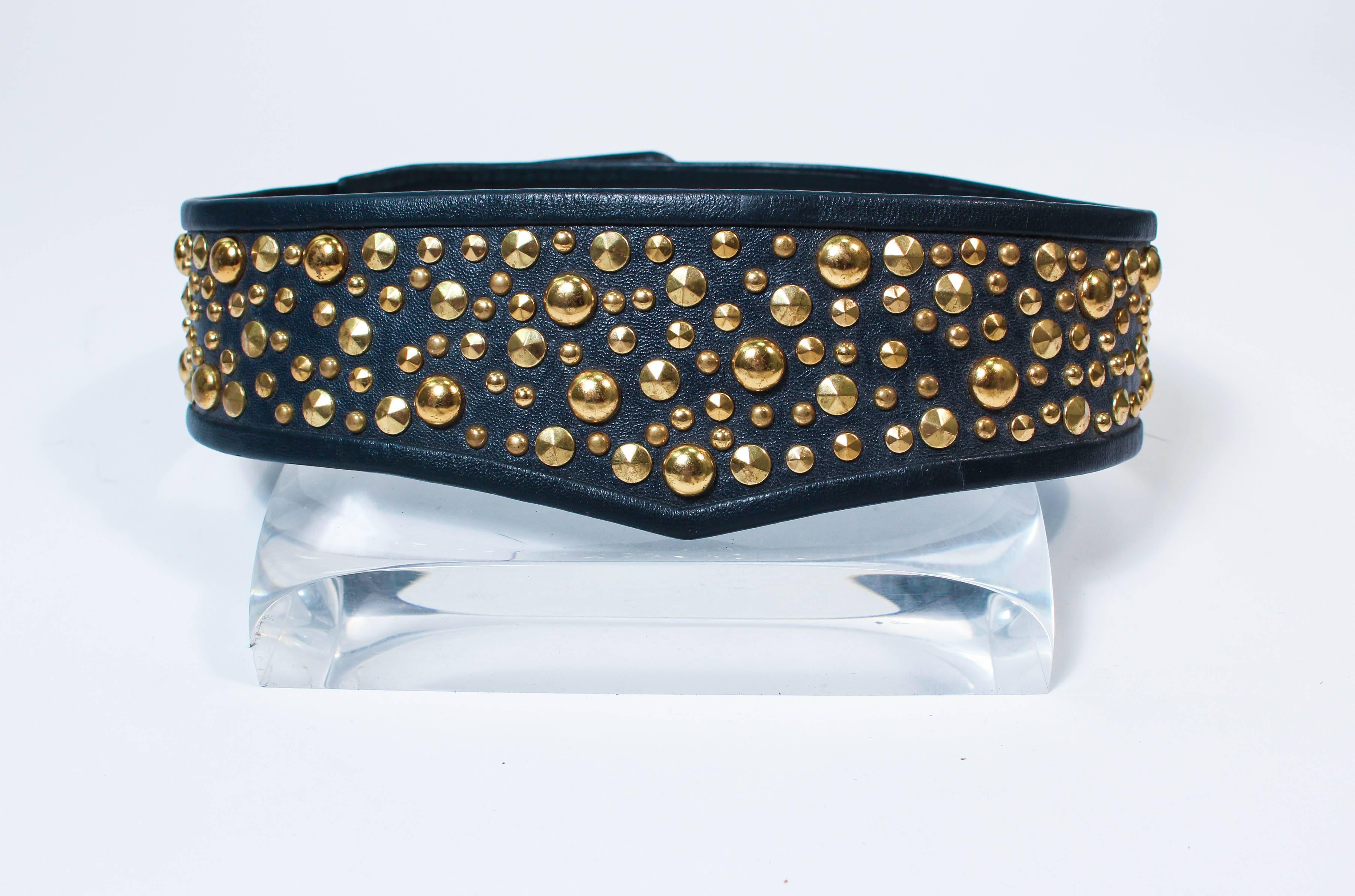 This Galanos belt is composed of a navy leather and features gold stud applique. Features three different optional lengths. In excellent vintage condition.

**Please cross-reference measurements for personal accuracy. Size in description box is an