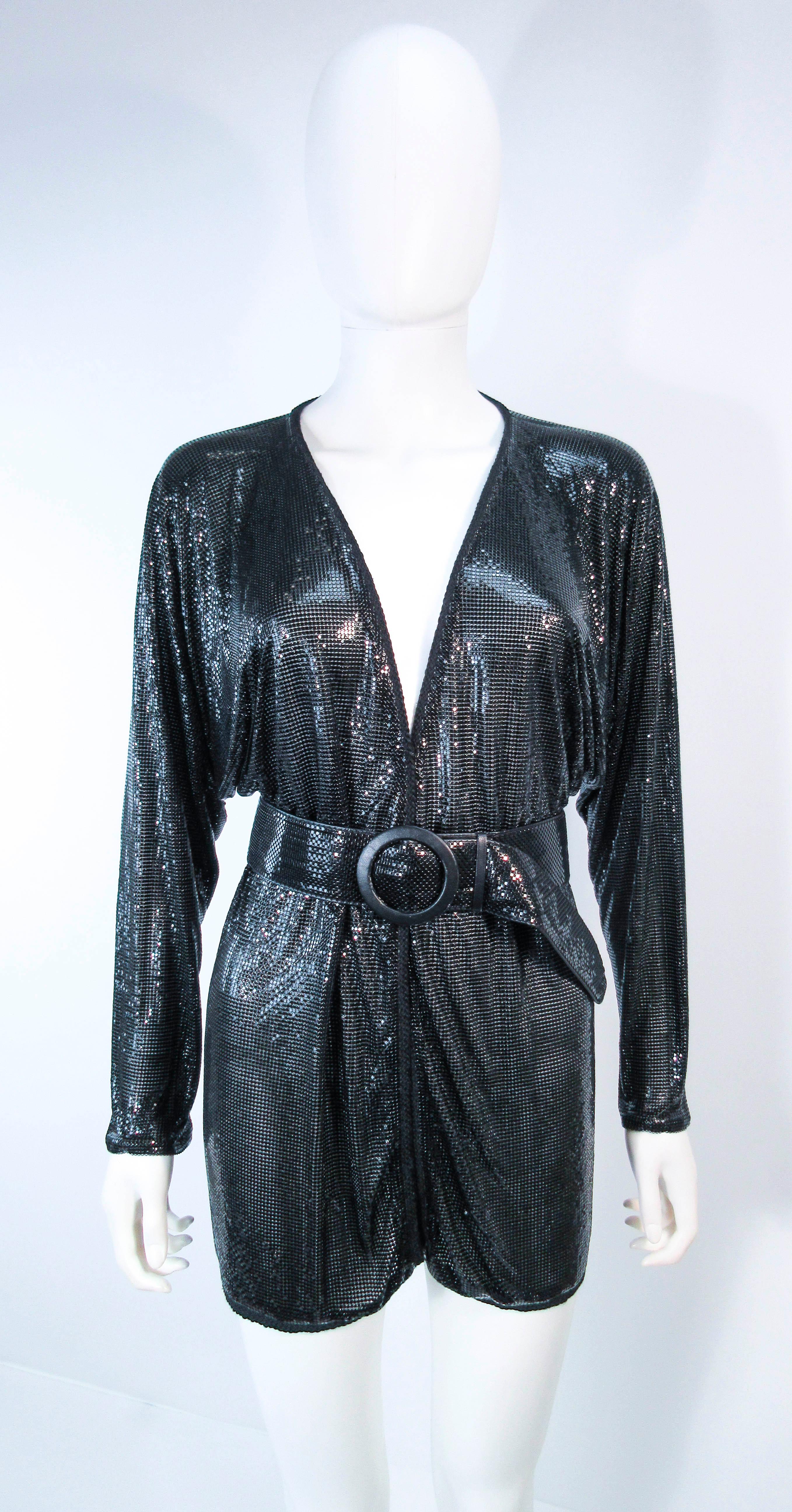 This Whiting and Davis design is composed of a black mesh. This item can be fashioned in variety of styles with or without the belt shown. Features center front hook & eyes with fabulous batwing sleeves.  In excellent vintage condition.

**Please