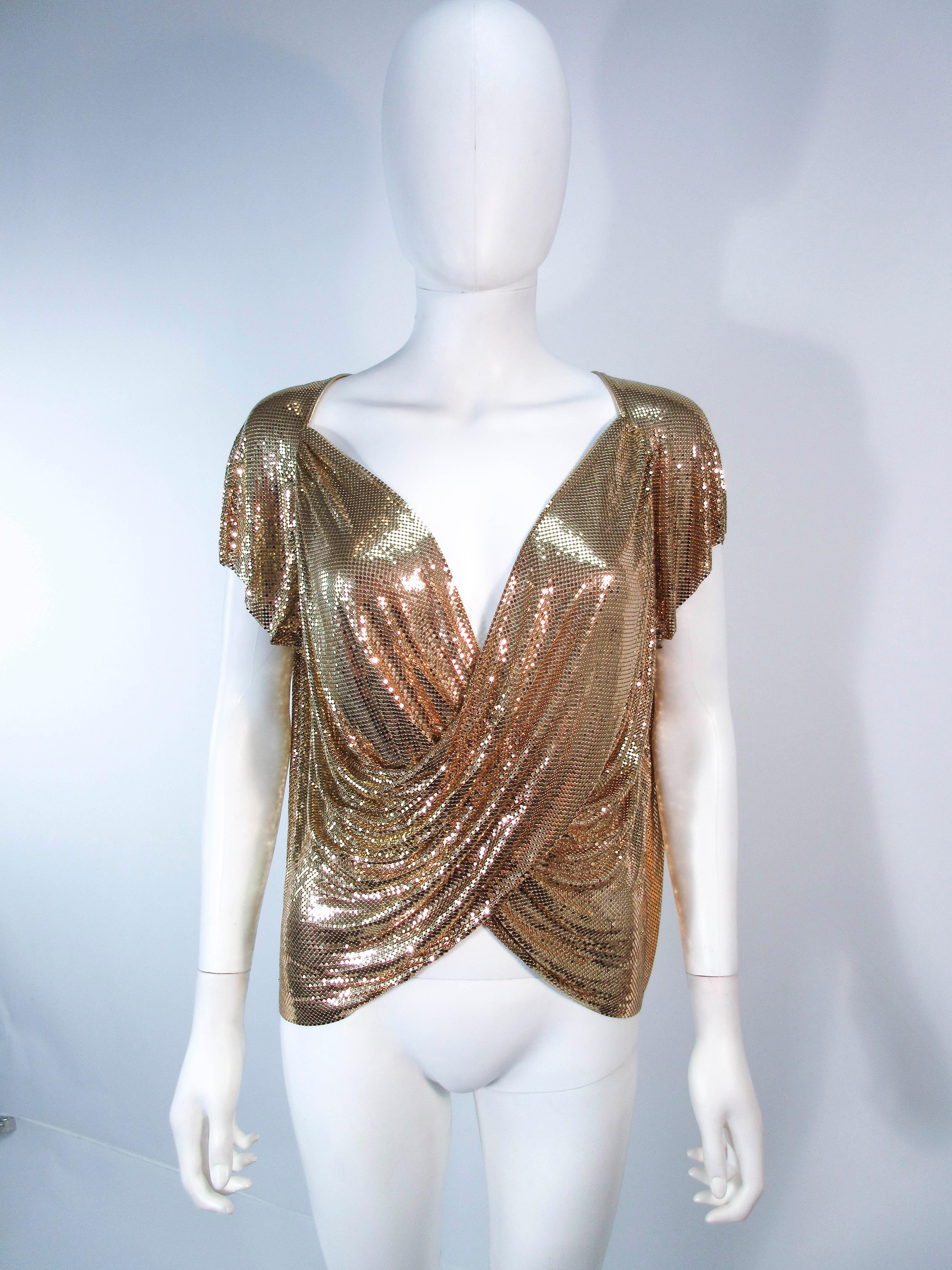 This Whiting and Davis design is composed of a gold mesh. This item can be fashioned as a draped in either direction. Features a side zipper closure. In excellent vintage condition.

**Please cross-reference measurements for personal accuracy. Size