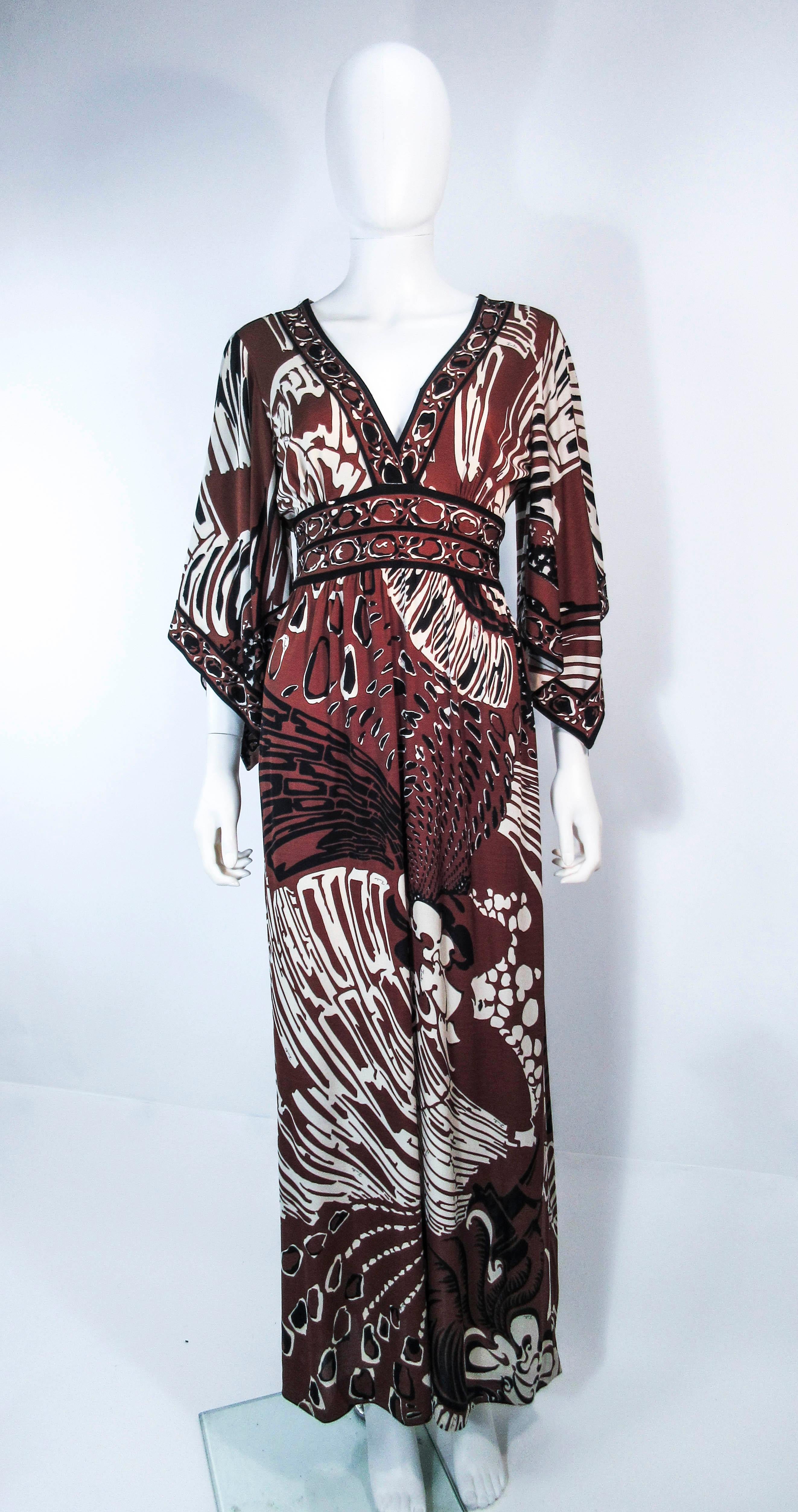 This Pucci dress is composed of a silk jersey with a wonderful bold abstract print. Features an empire waist with a v-neck. There is a side zipper. In excellent vintage condition, small unnoticeable mends. 

**Please cross-reference measurements for