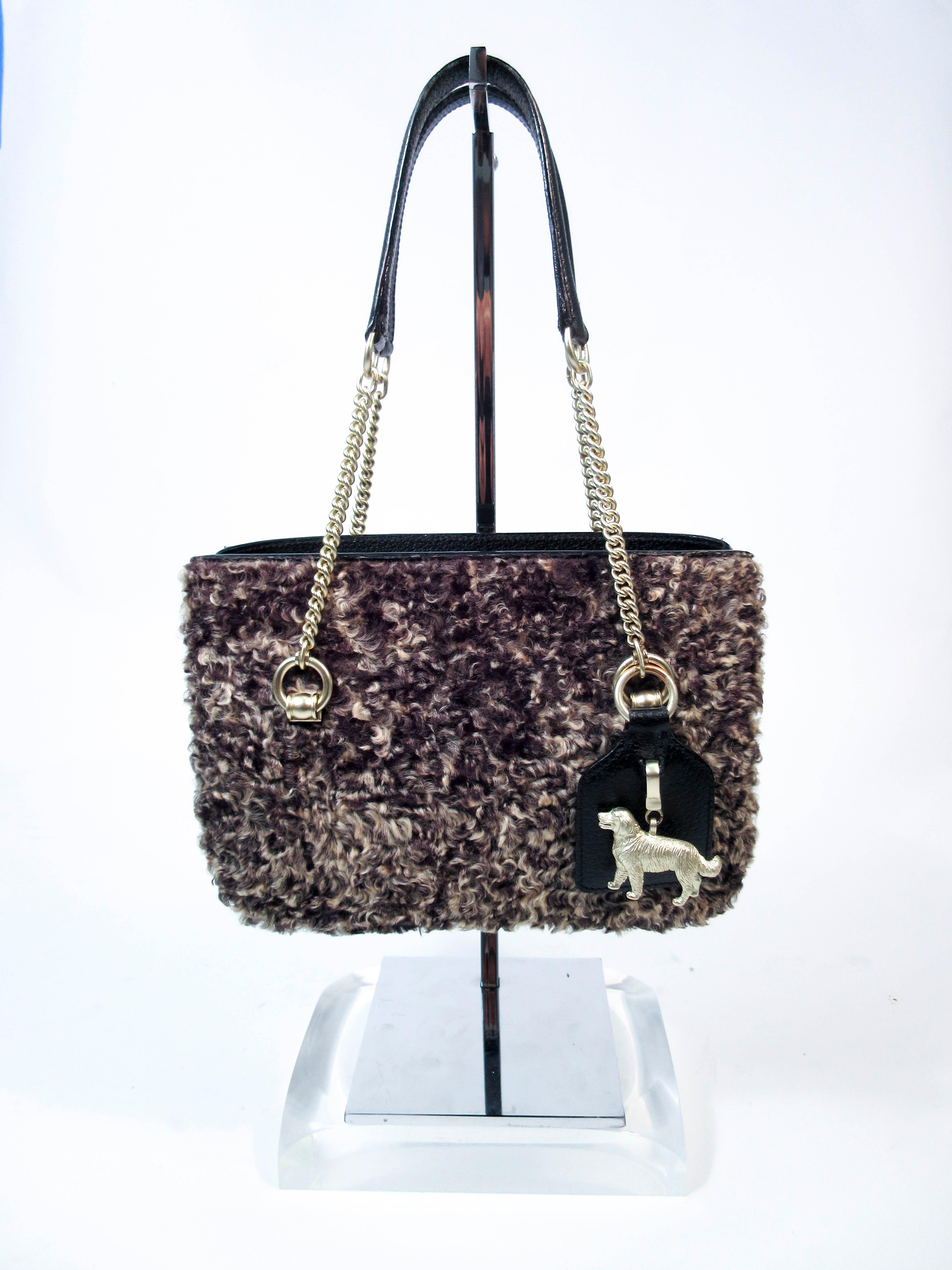 This Barry Keiselstein Cord purse is composed of a beautiful curly lamb with gold hardware 'Dog' accents. Features an interior zipper compartment with two side compartments, comes with dustbag. In excellent almost new pre-owned condition (some signs