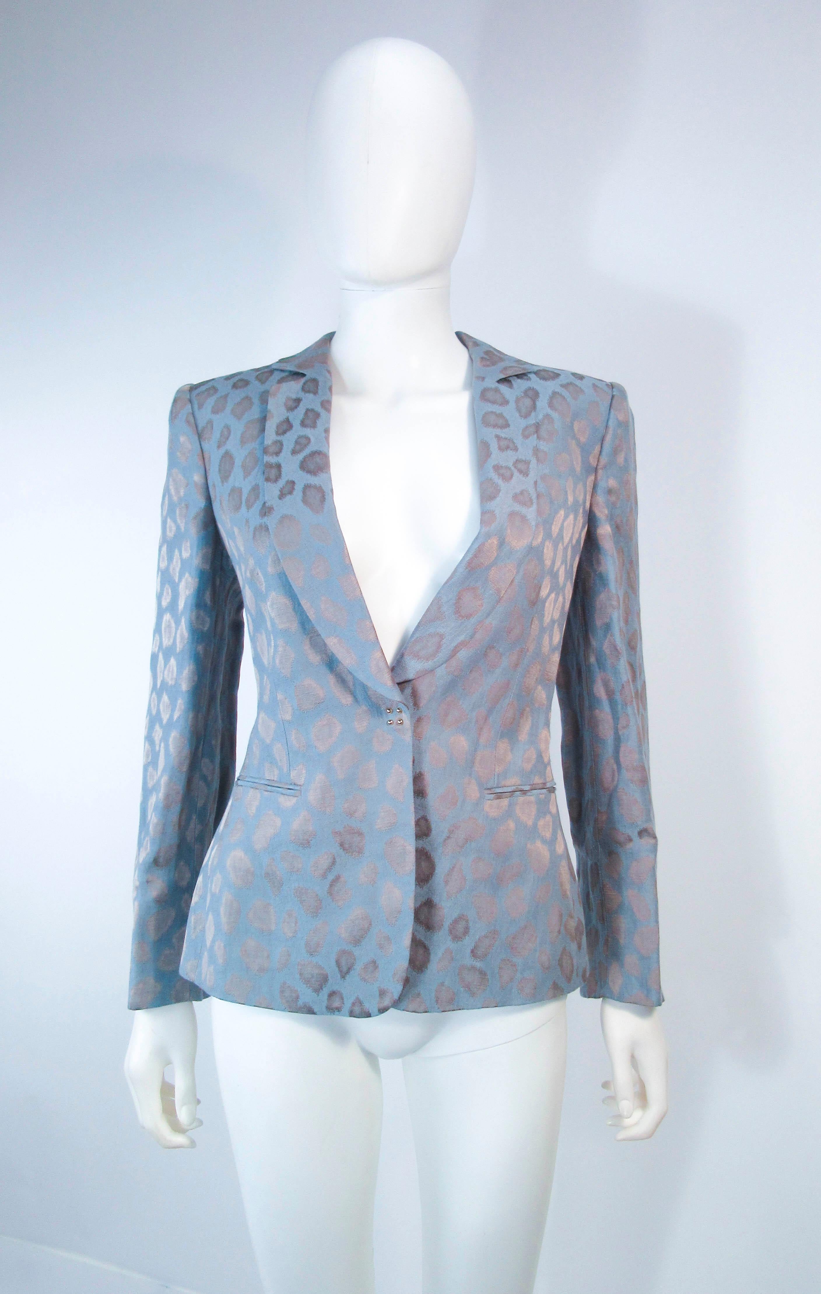 This Giorgio Armani is composed of a blue silk with a wonderful animal print. Features center front snap button closures. In excellent pre-owned condition. 

**Please cross-reference measurements for personal accuracy. Size in description box is an
