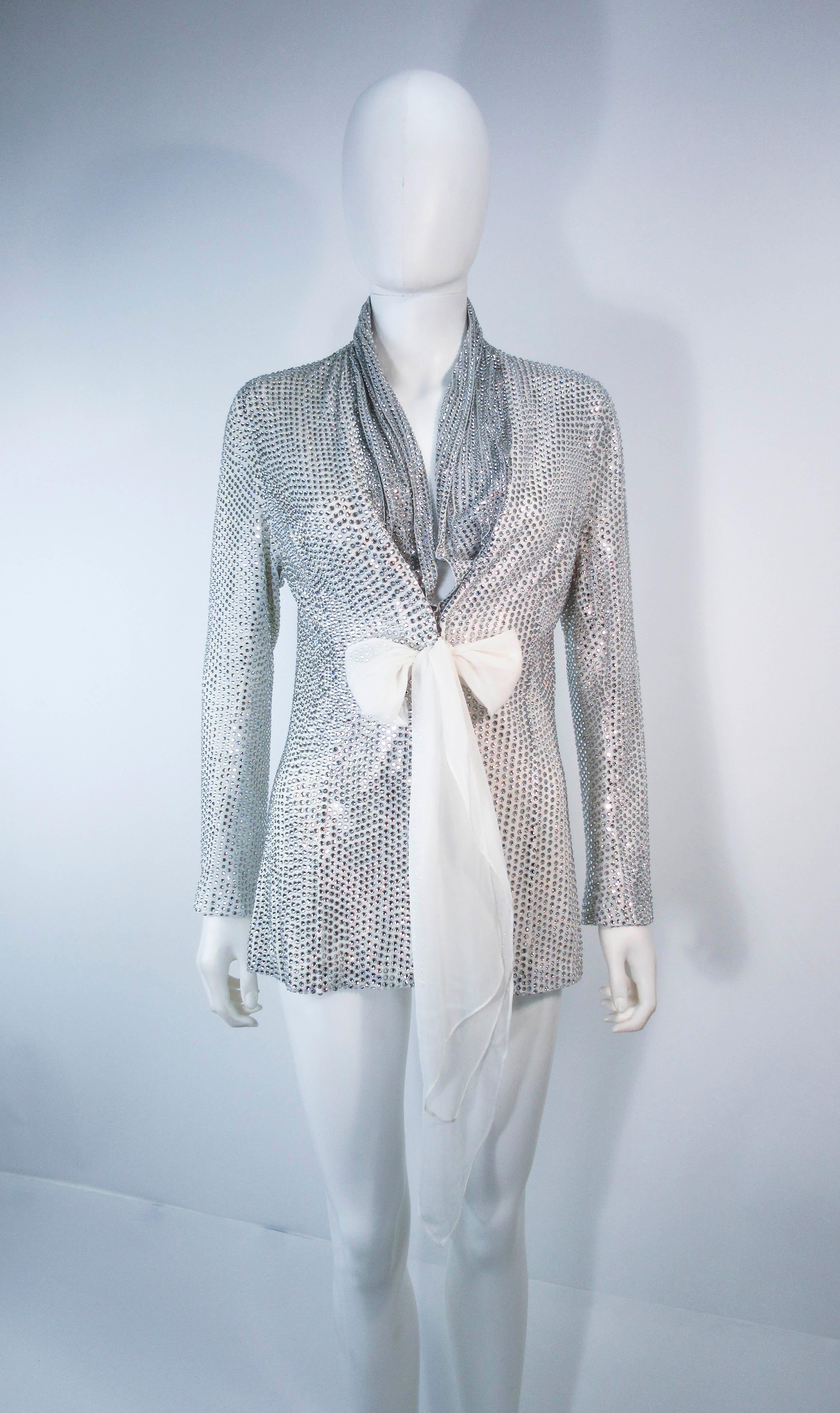 
LSO Designs, 100% silk lined, all-over heat pressed glass rhinestone. This is a custom made jacket that features a center front closure and white silk chiffon draped sash.

In excellent vintage condition.

**Please cross-reference measurements for