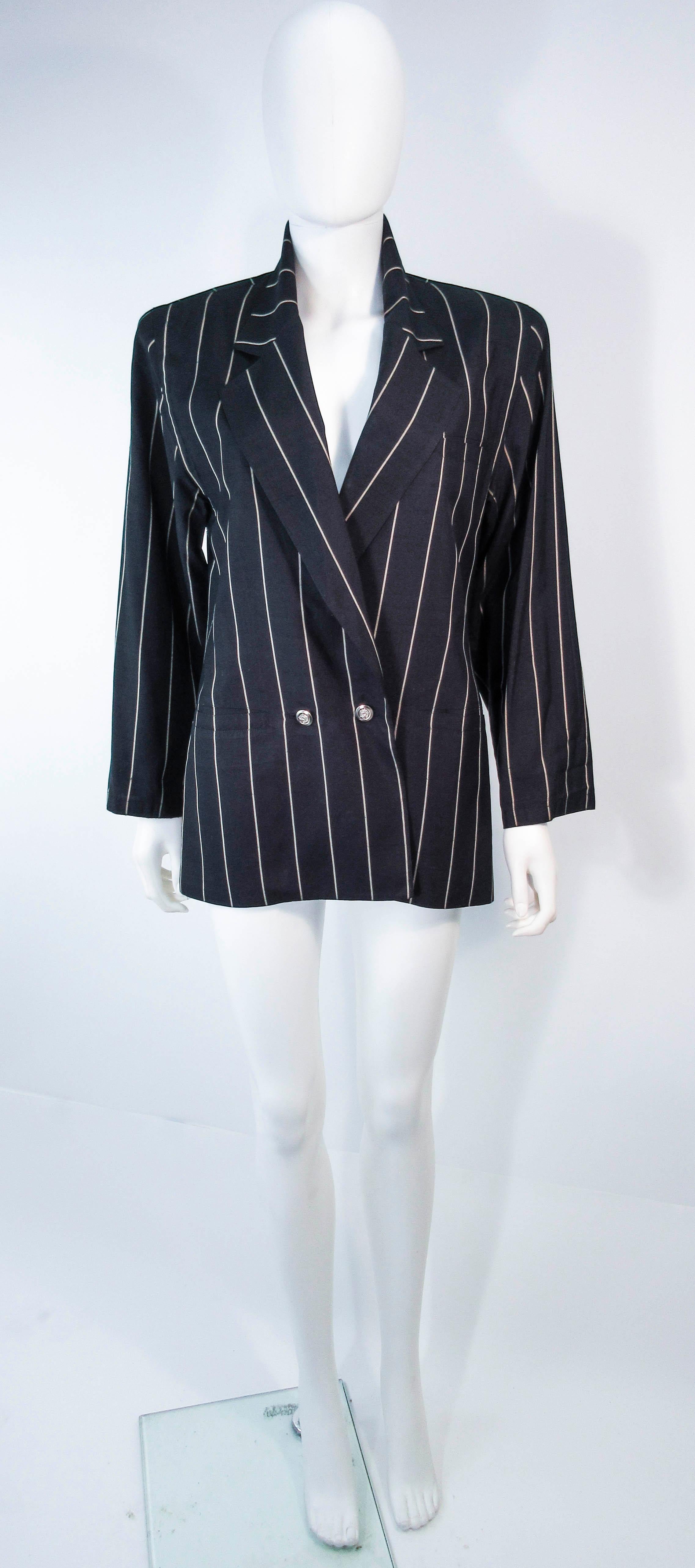 This vintage Versace coat is composed of a light weight black & cream striped textile. Features a center front button closure & pockets. In excellent vintage pre-owned condition, some wear (see photos). 

**Please cross-reference measurements for