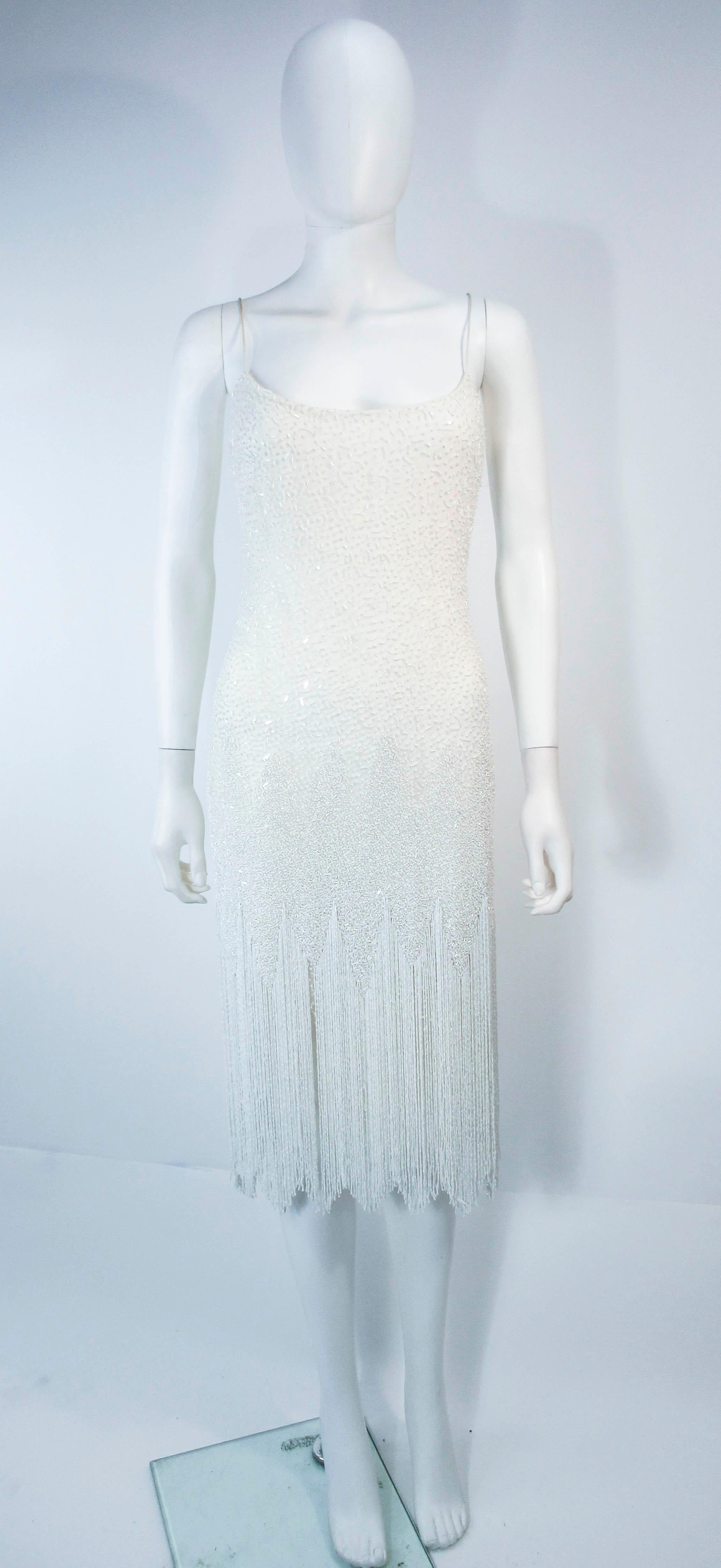 This Naeem Khan design is composed of a beautiful beaded mesh over silk. Features a gorgeous fringe hem and classic spaghetti strap style. In excellent vintage pre-owned condition, some wear (see photos). 

**Please cross-reference measurements for